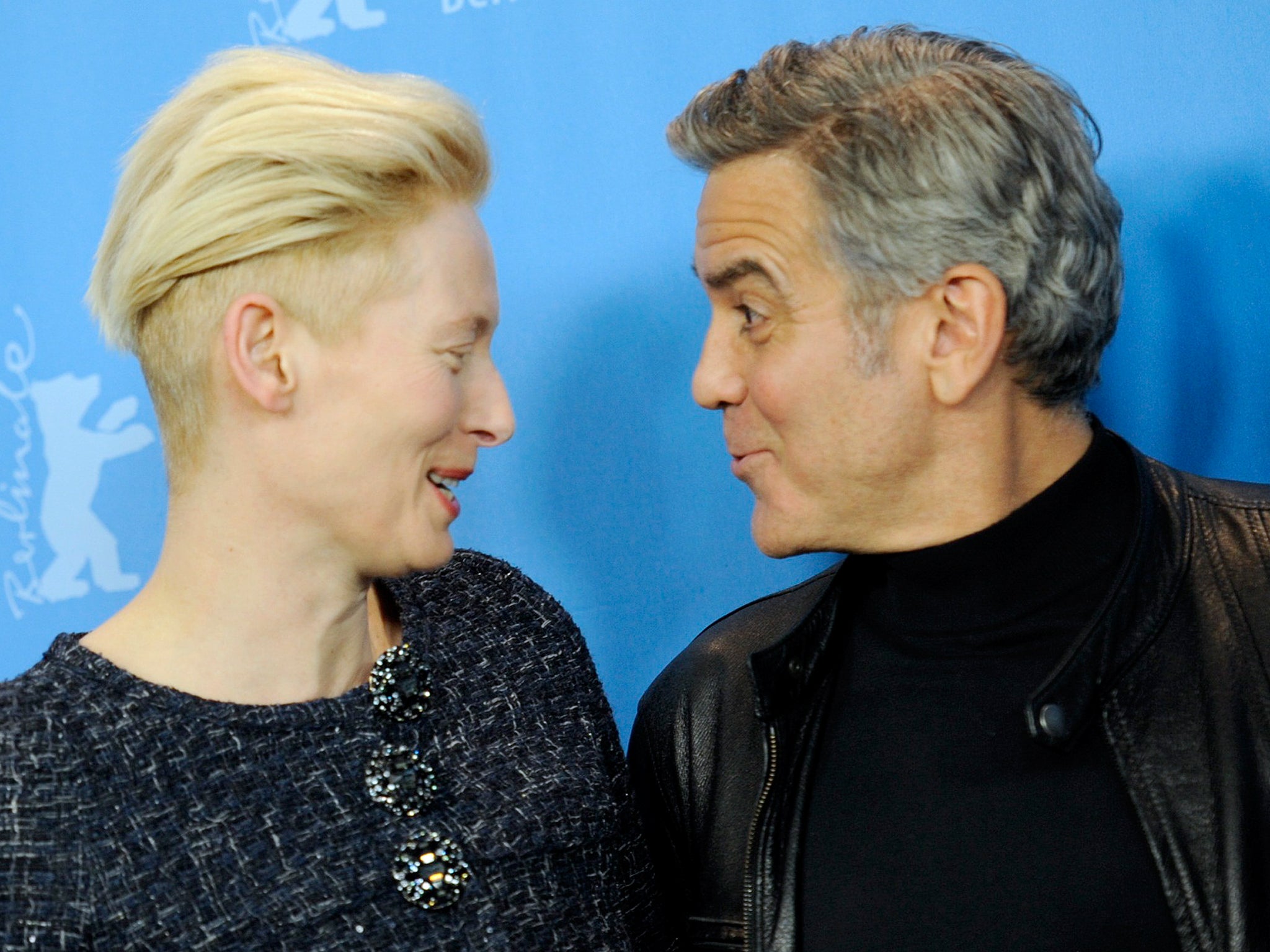 Actors George Clooney and Tilda Swinton smile at the photocall to promote the movie 'Hail, Caesar!' at the 66th Berlinale International Film Festival in Berlin, Germany