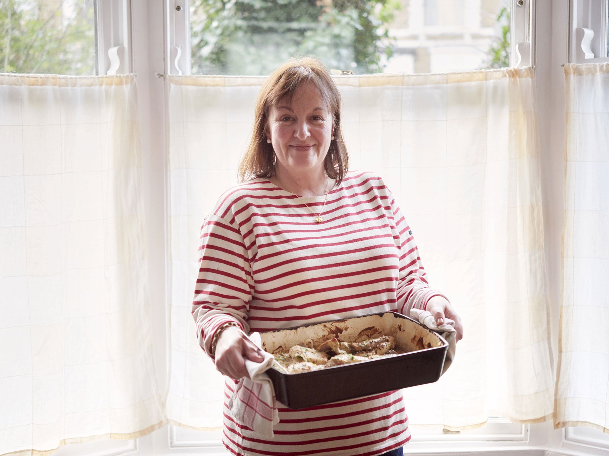 Debora takes the rabbit in mustard sauce out of the oven