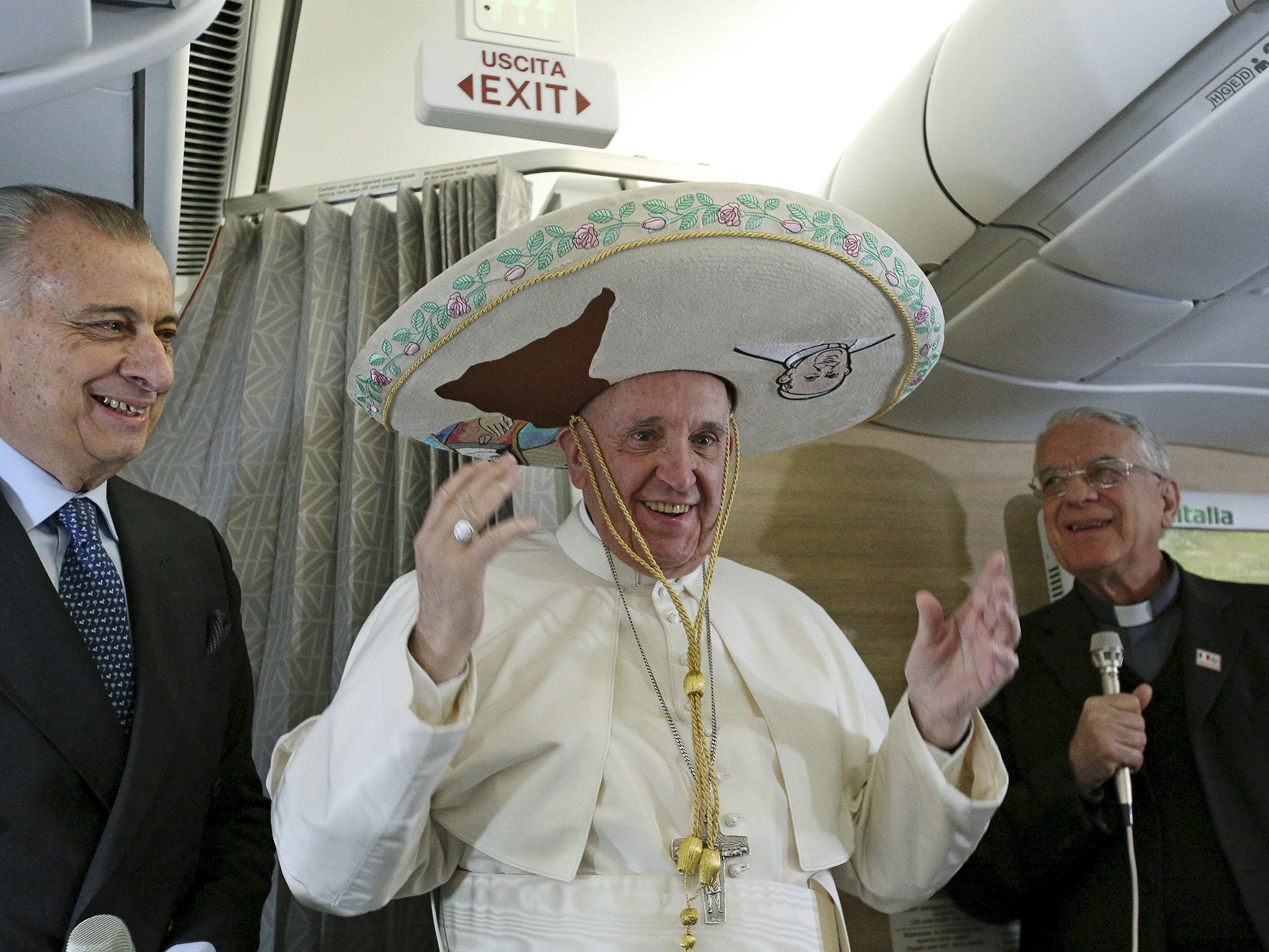 Pope Francis wears a Sombrero hat he received as a gift by a Mexican journalist aboard an airplane to Havana, February 12, 2016.