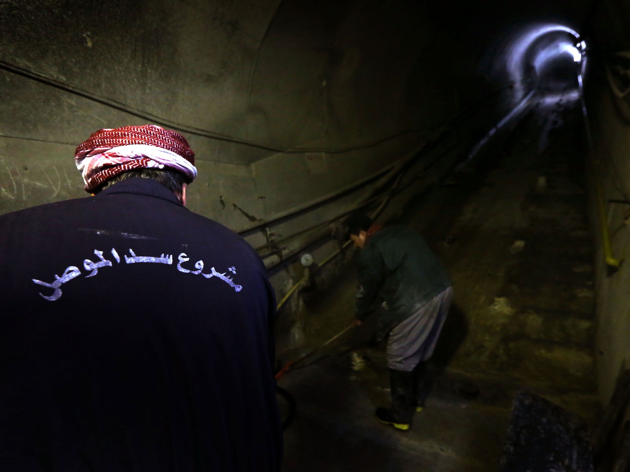 Workers operate inside the dam