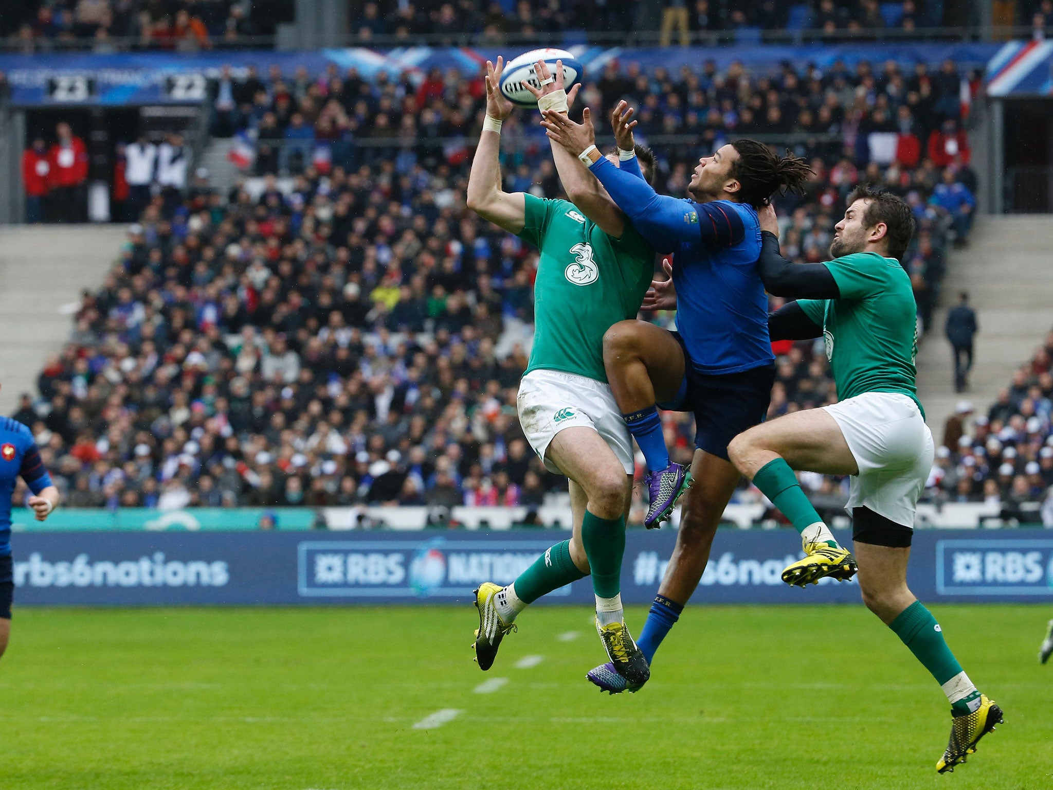 Ireland's Nathan White and Jared Payne challenge Teddy Thomas of France in the air