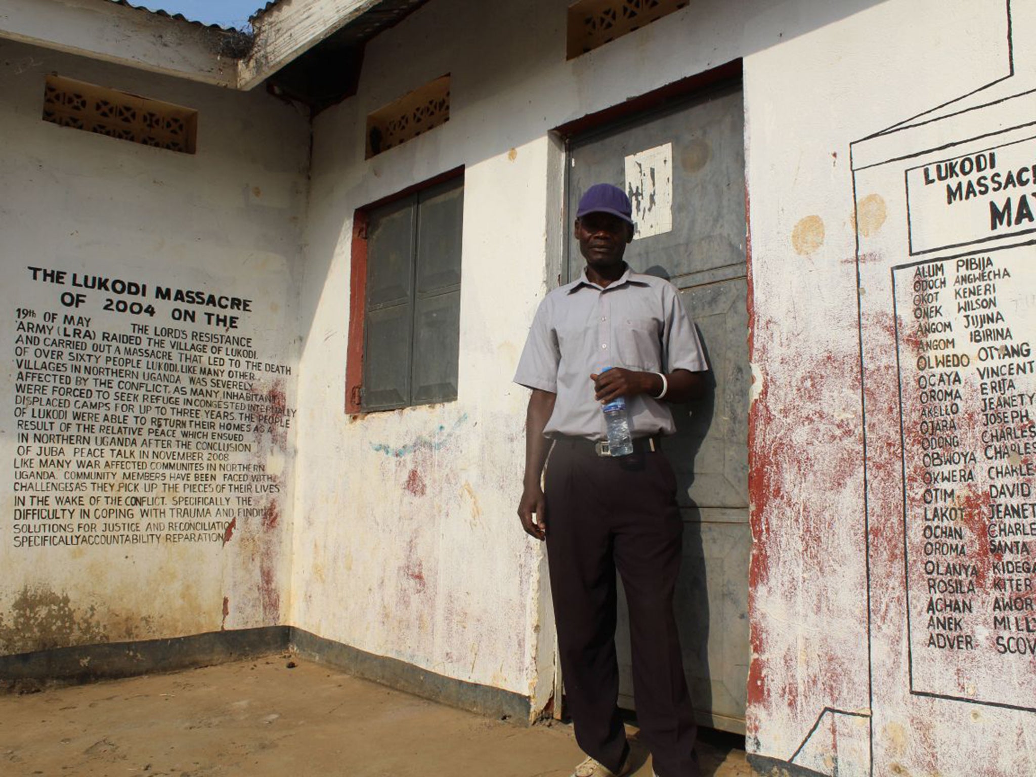 Justin Ochan at the memorial to the victims of the 2004 Lukodi massacre