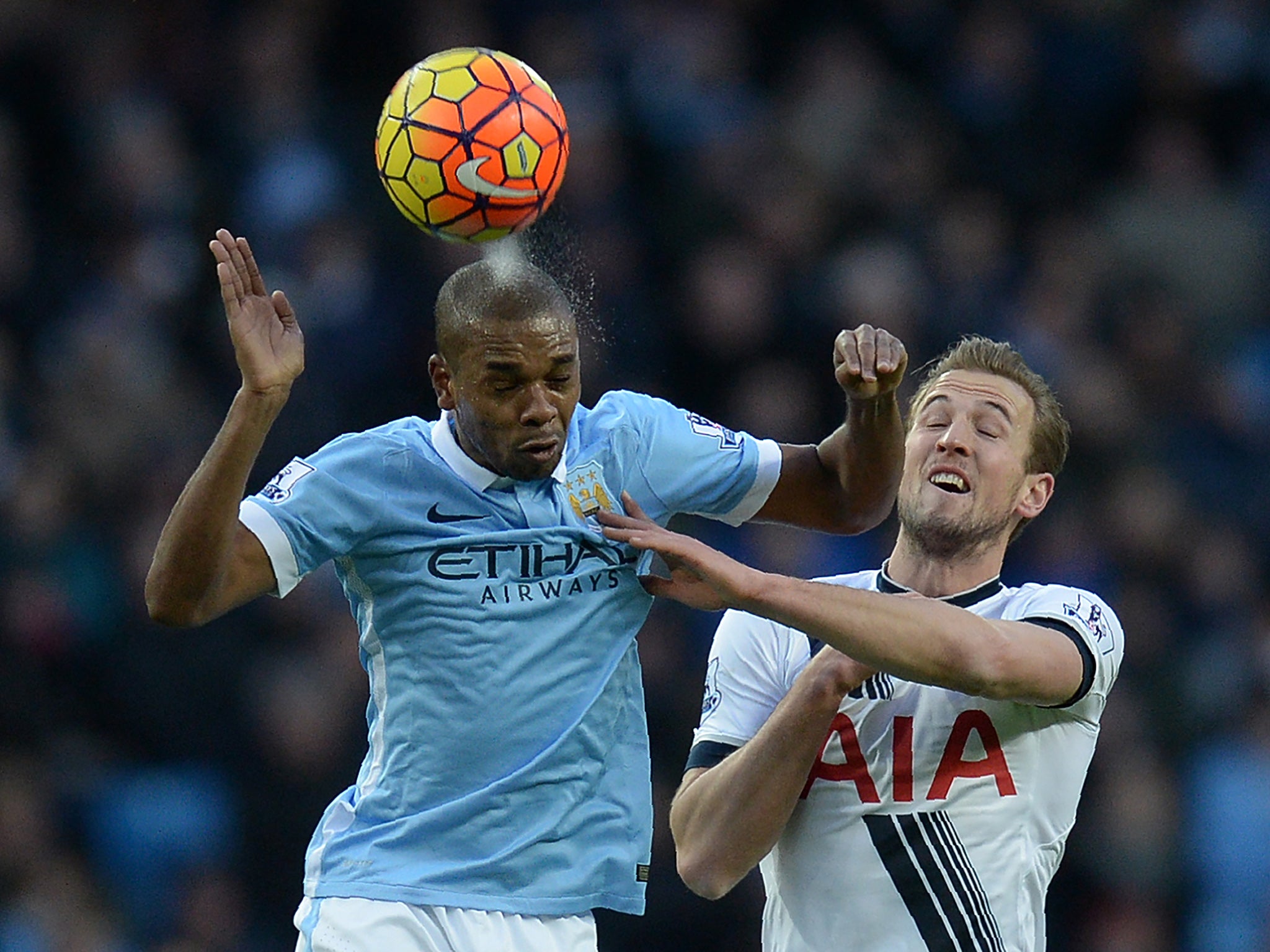 Harry Kane and Fernandinho contest for the ball