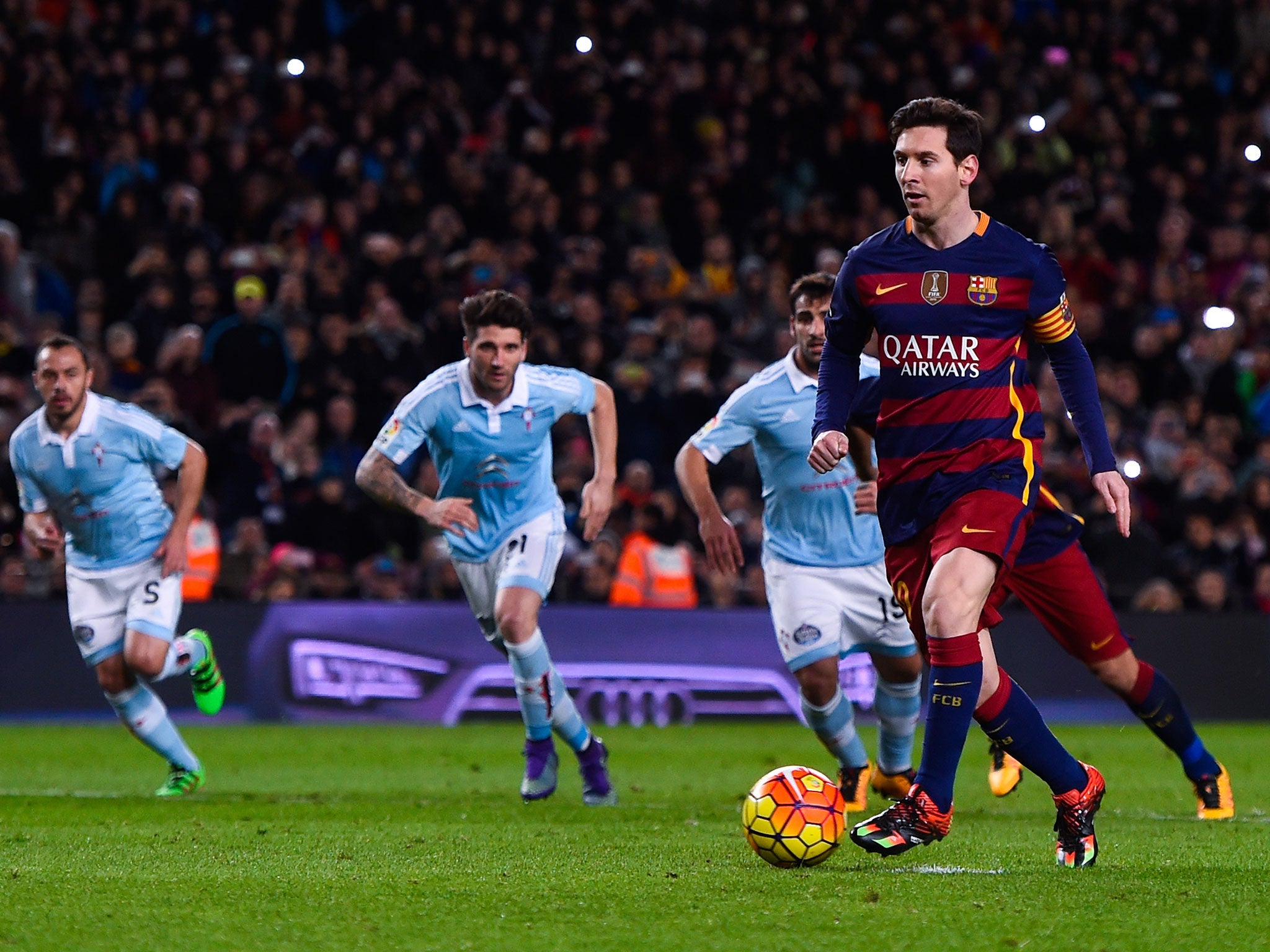 Lionel Messi approaches the penalty before passing it to his right...