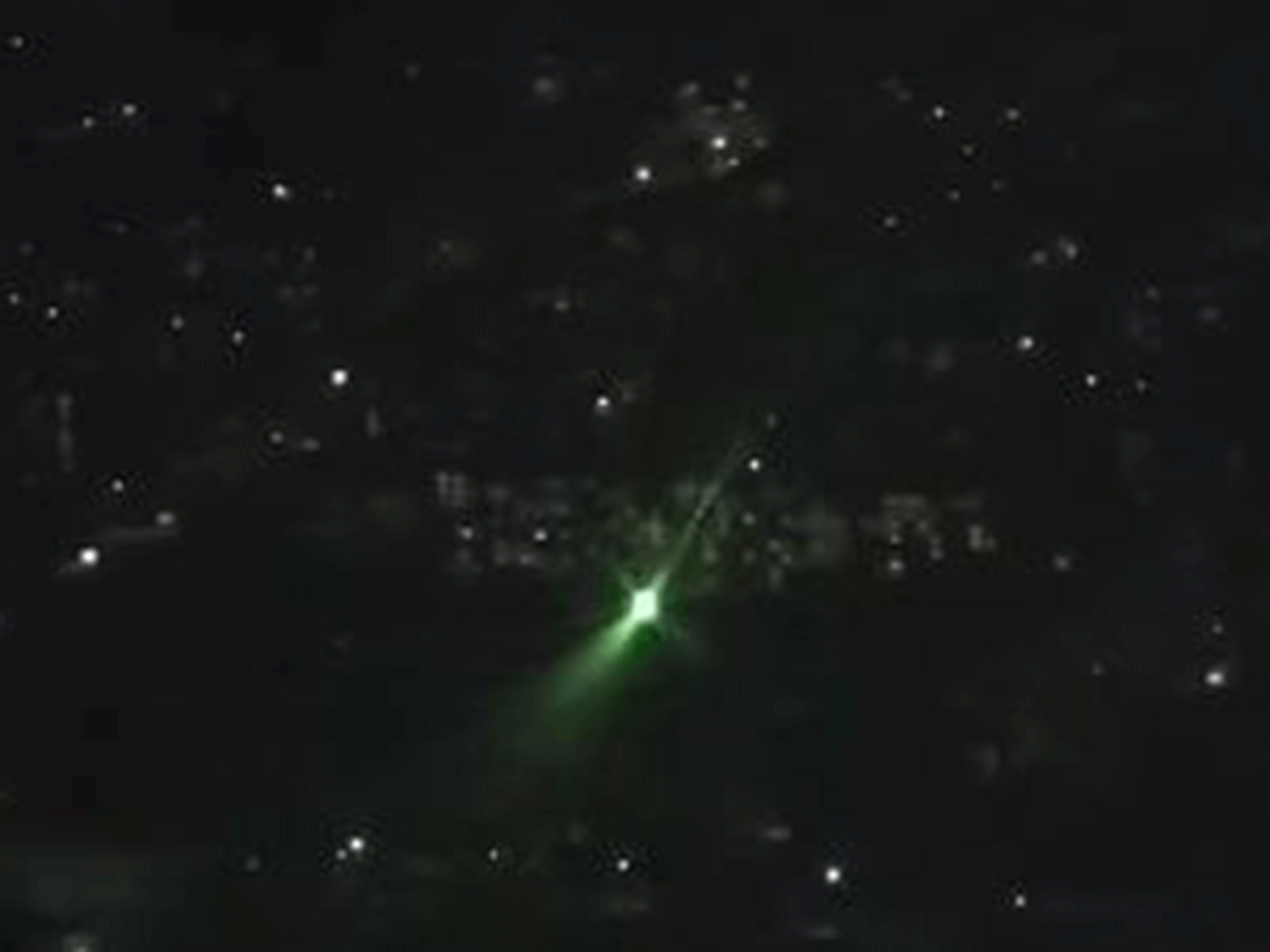 The view from the cockpit: a green laser is pointed from a residential area