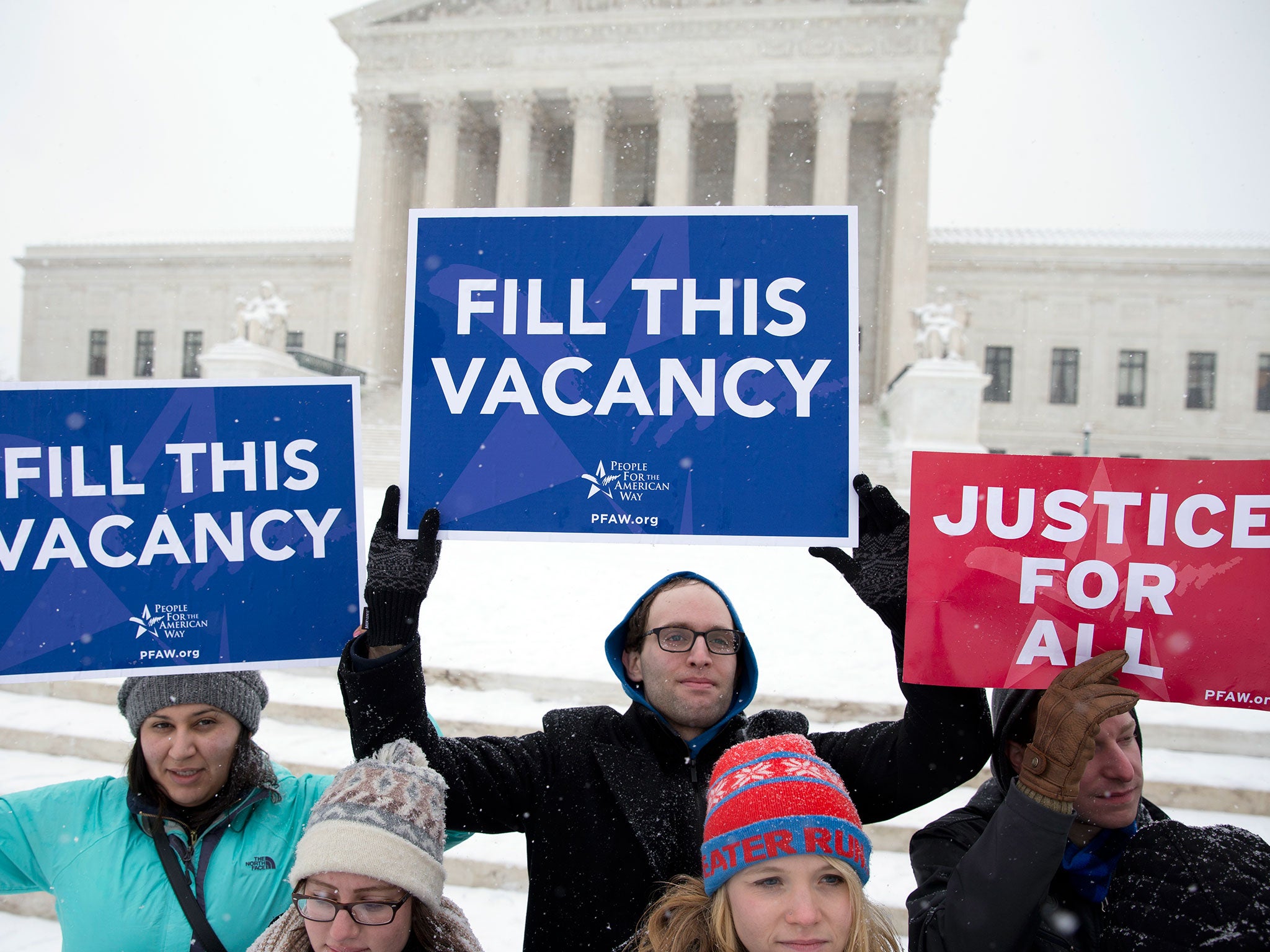 Demonstrators from the "People for the American Way" group gather with signs in front of the US Supreme Court in Washington to call for Congress to give fair consideration to any nomination put forth by President Obama