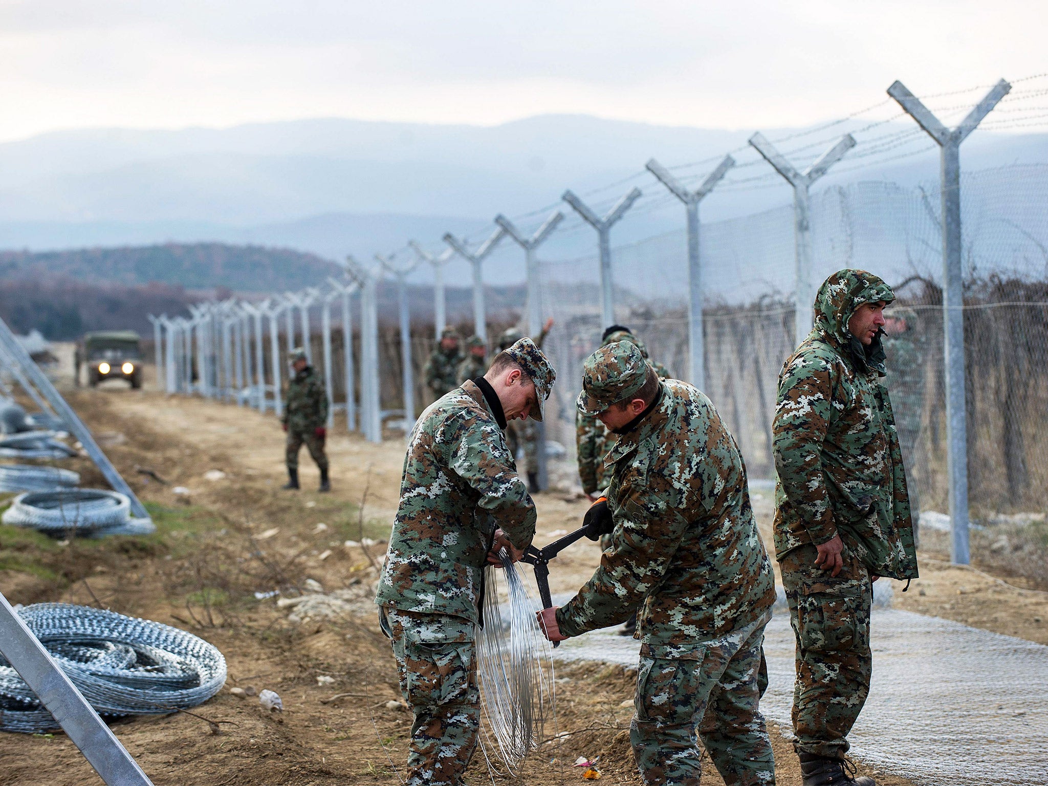 Macedonian soldiers build a second border fence to prevent illegal crossings by migrants at the border with Greece