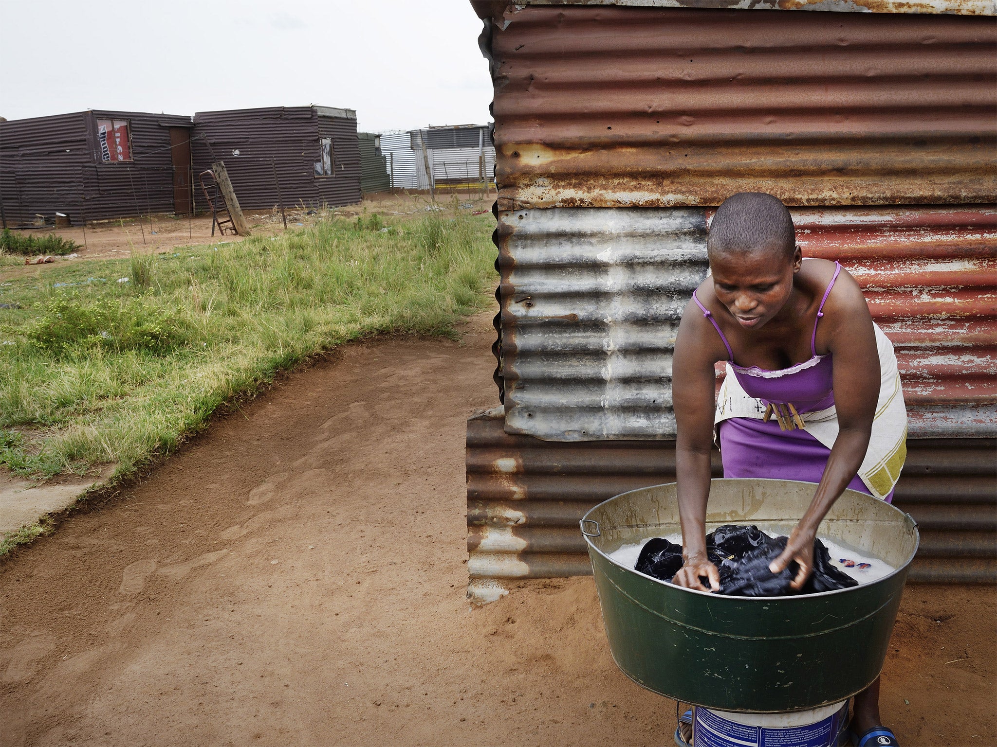 One of the slain farmworkers rented a room in the brown shack at left, in Winnie Section, an informal settlement on the edge of Tumahole township