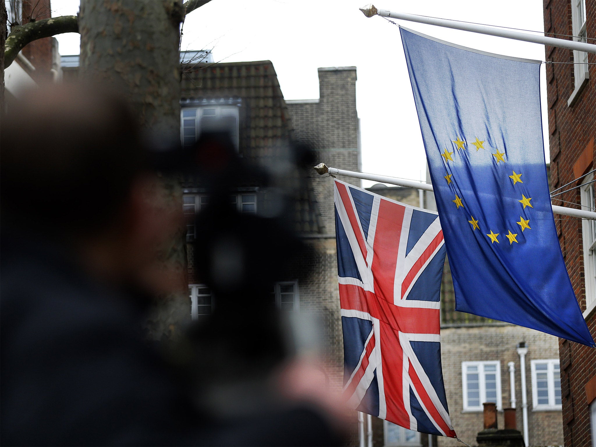 A camera man films outside Europa House in London. Agreement at the summit would allow a referendum to be held as early as June