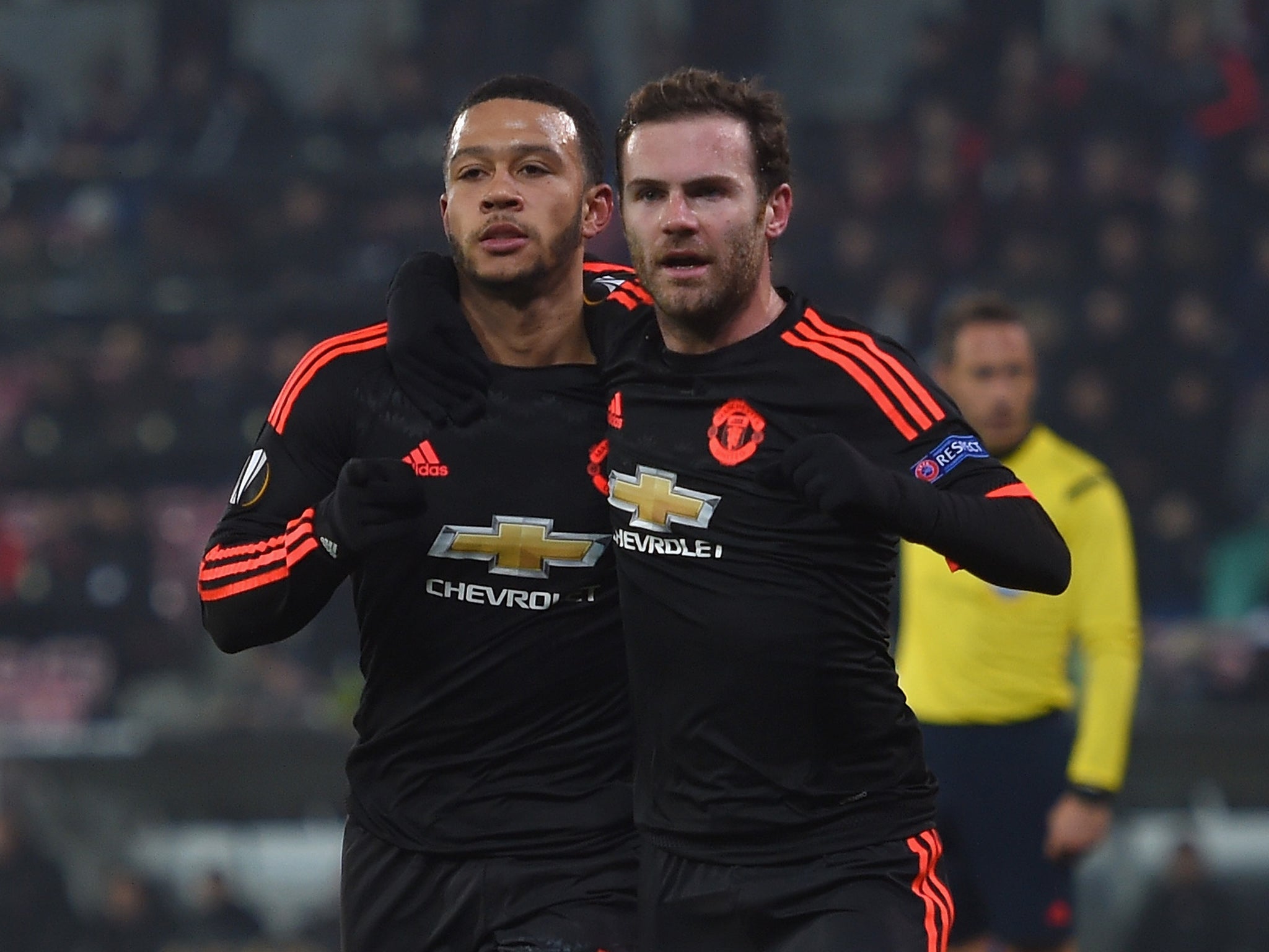 Manchester United winger Memphis Depay celebrates his goal with Juan Mata