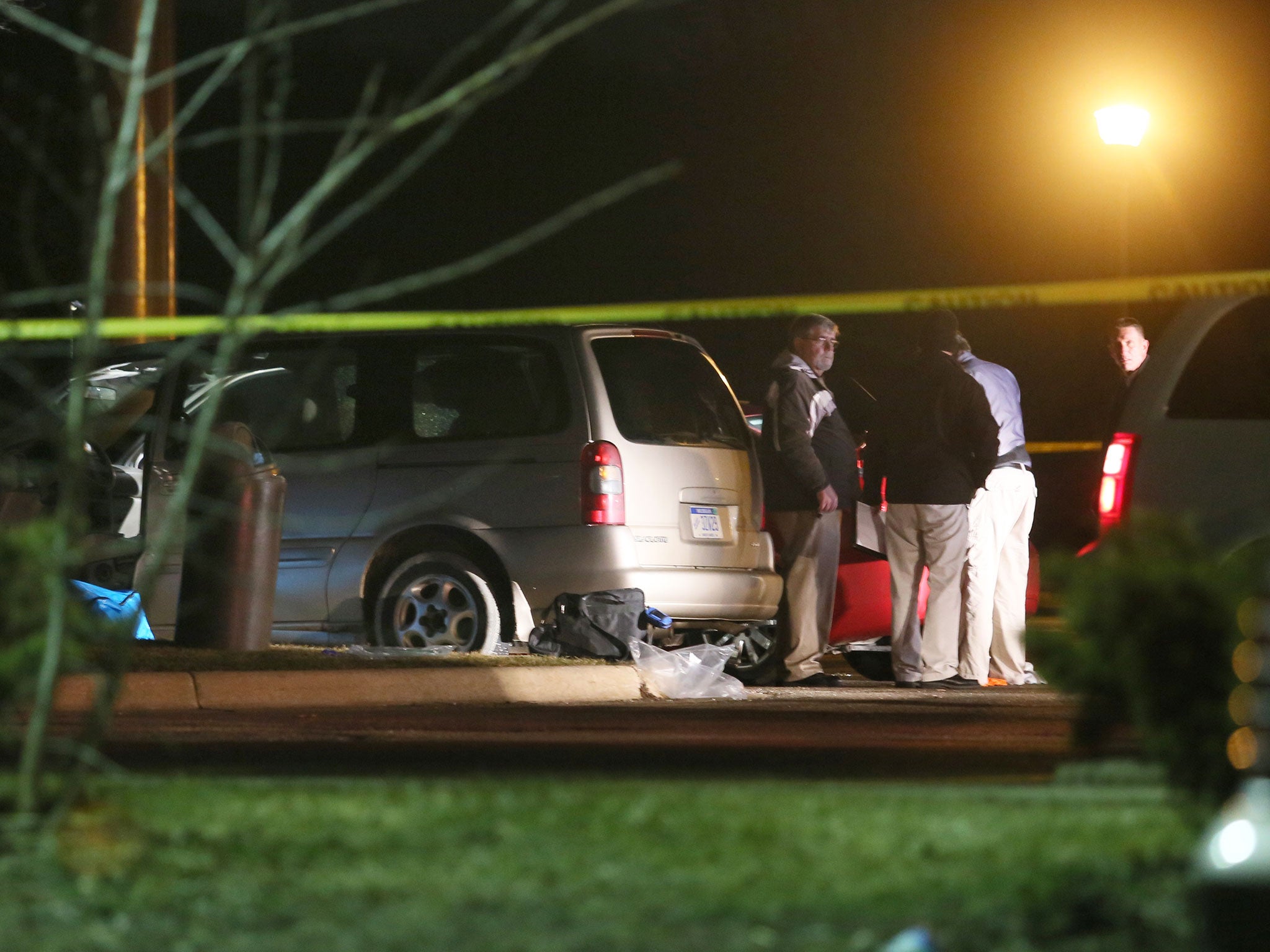 Police investigate the scene early Sunday, 21 February, 2016, where people were shot in vehicles outside a Cracker Barrel restaurant in Kalamazoo, Michigan