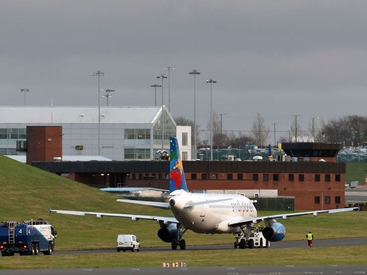 Fire and rescue teams recover an Airbus A320 which went off the runway and ended up on the grass verge after landing at Birmingham Airport