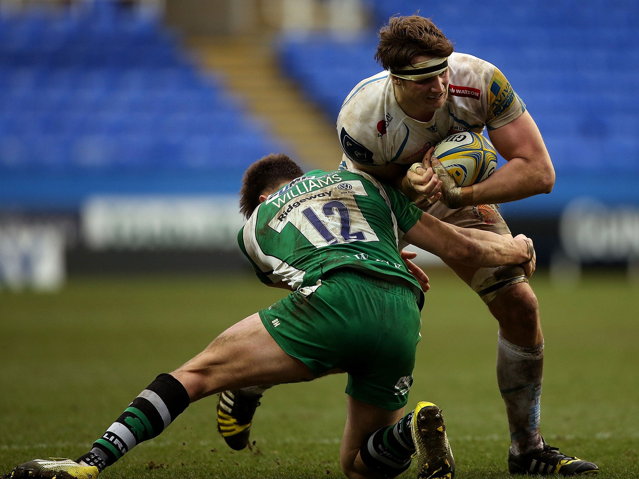 Johnny Hill of Exeter is tackled by Johnny Williams of London Irish