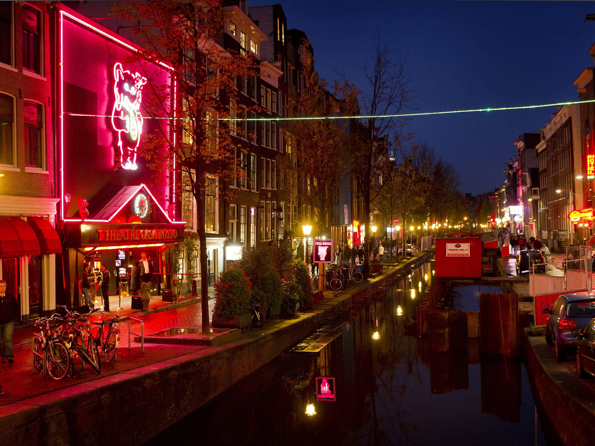 People walk through the red-light district, known as De Wallen, in Amsterdam