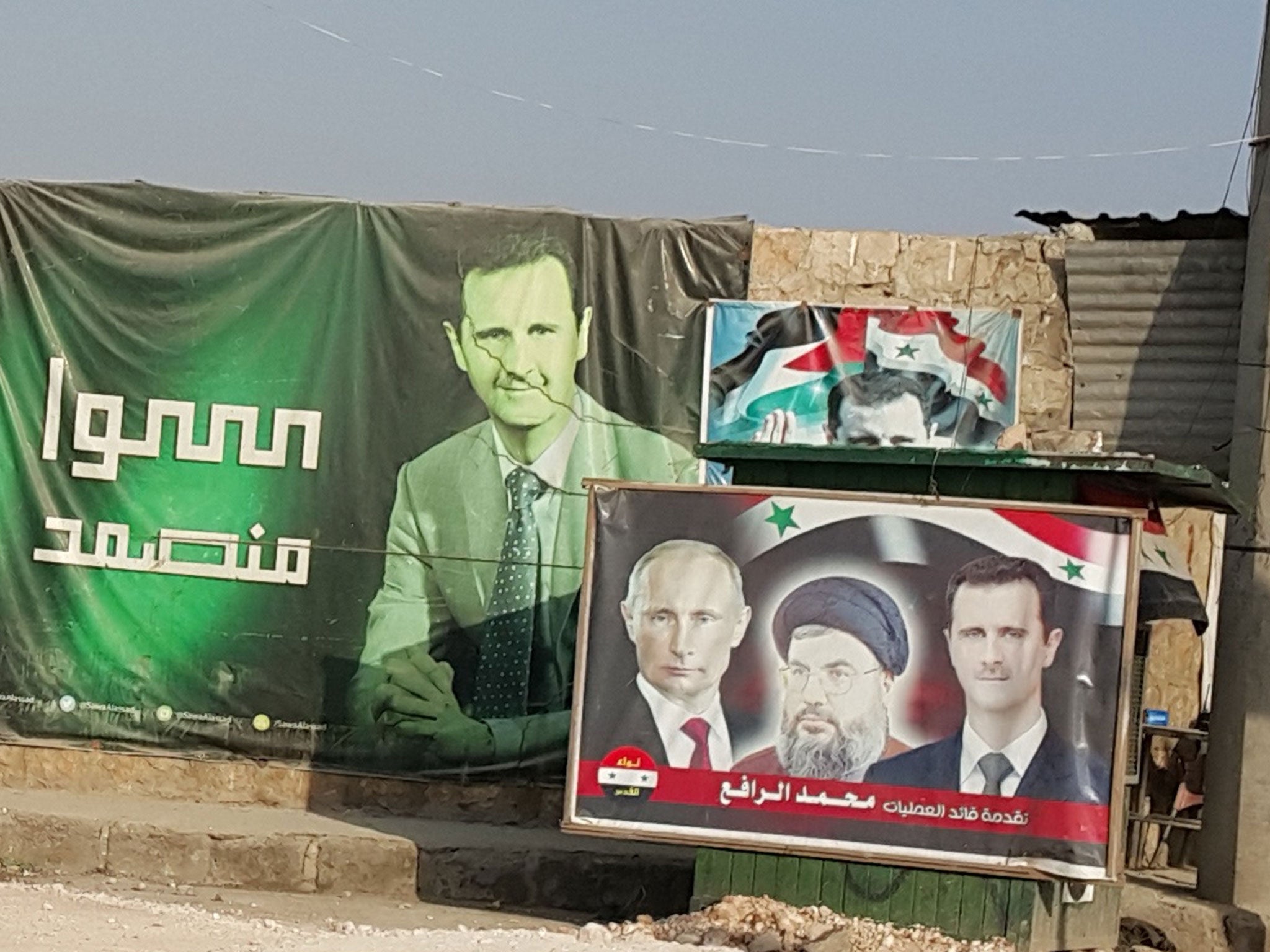 A poster in Nubl featuring Vladimir Putin, Bashar al-Assad and the Hezbollah leader Sayed Hassan Nasrallah