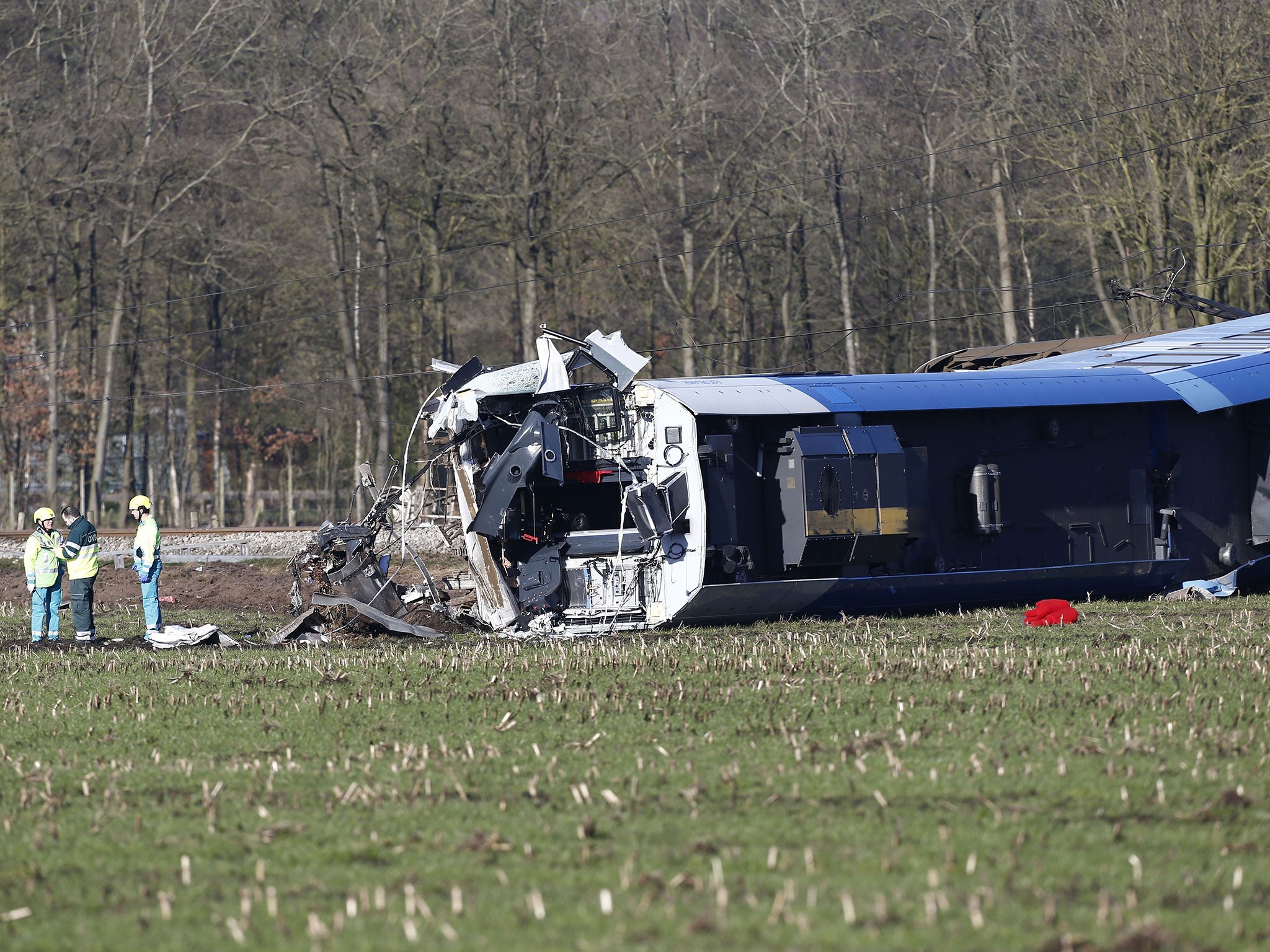 Emergency services intervene on the scene of a derailed passengers train near Dalfsen, eastern Netherlands, on 23 February, 2016