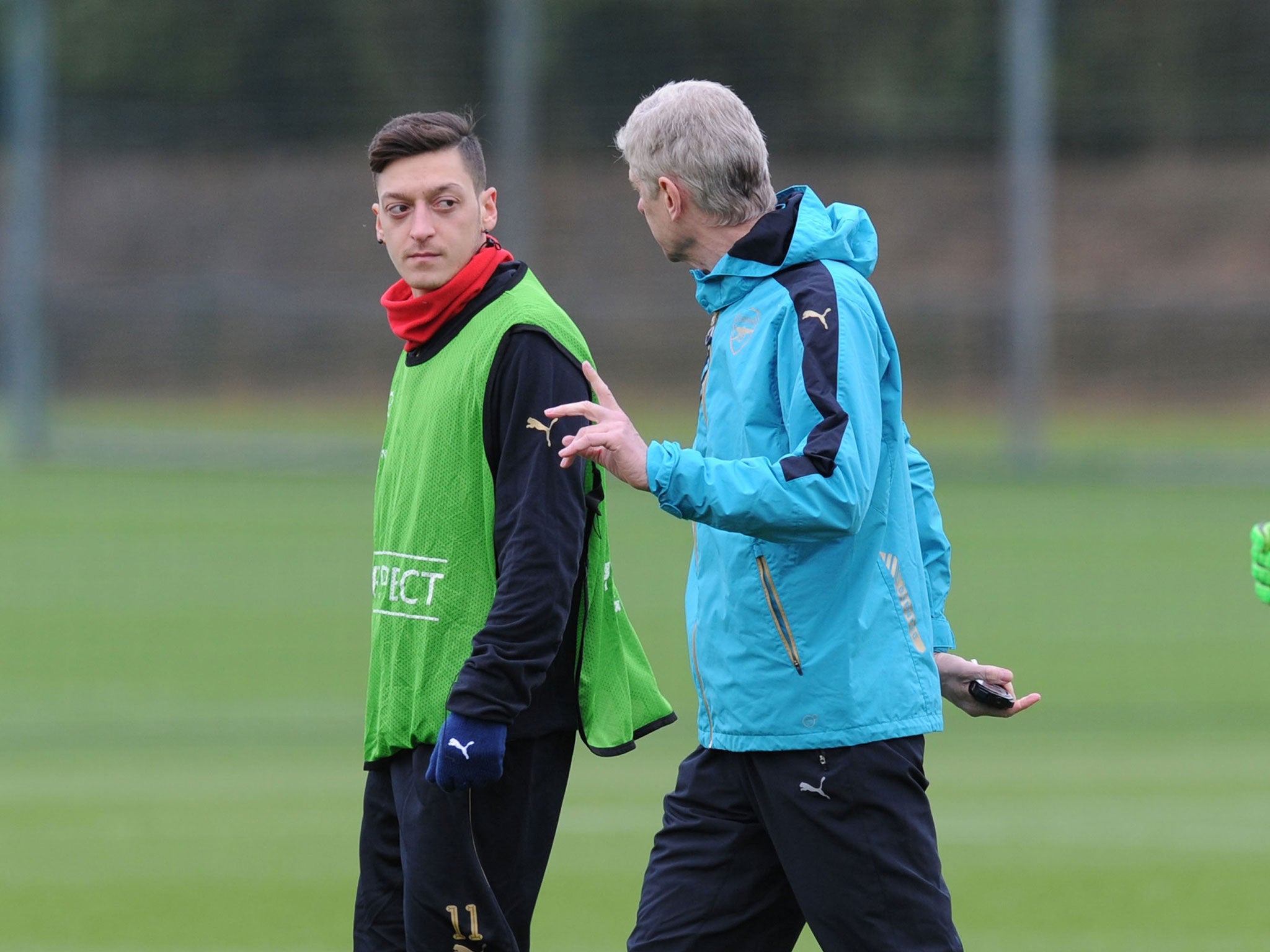 Mesut Ozil talks with Arsene Wenger