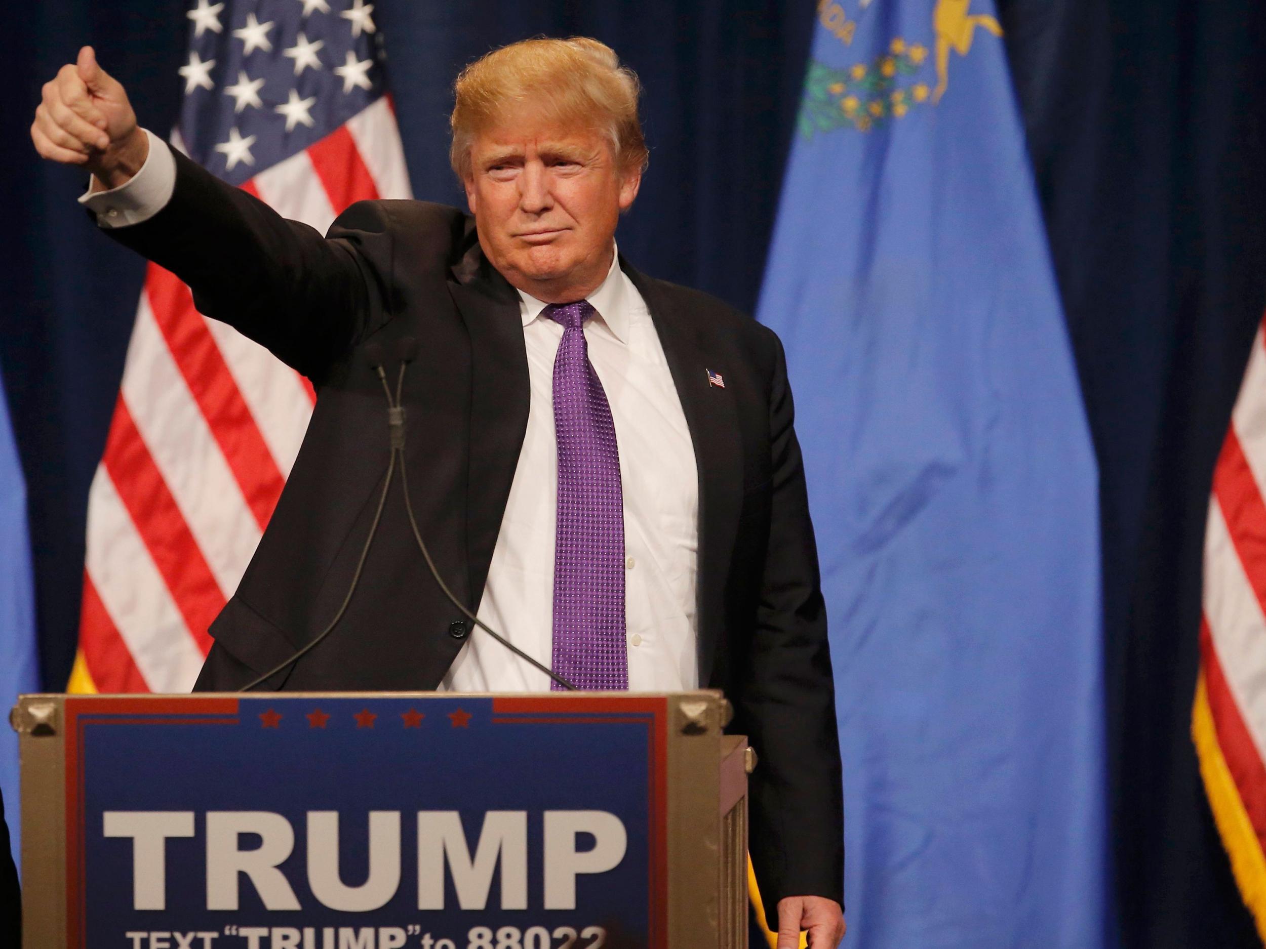 Trump gives a thumbs up to the crowd after being declared winner of the Nevada Repulican caucuses at his caucus night rally in Las Vegas