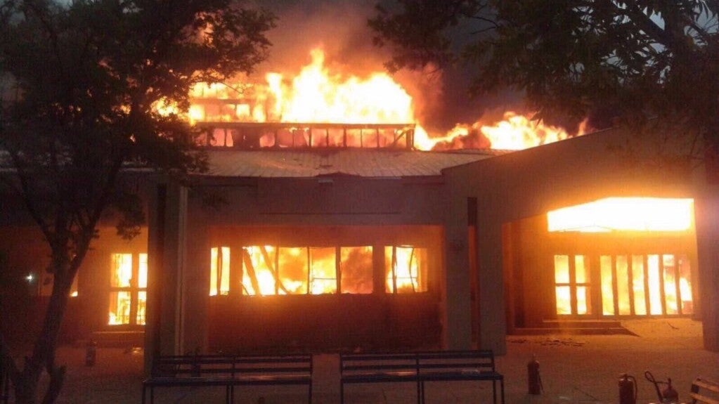 One of the university's buildings burns on Wednesday as management ordered all students to 'leave immediately'