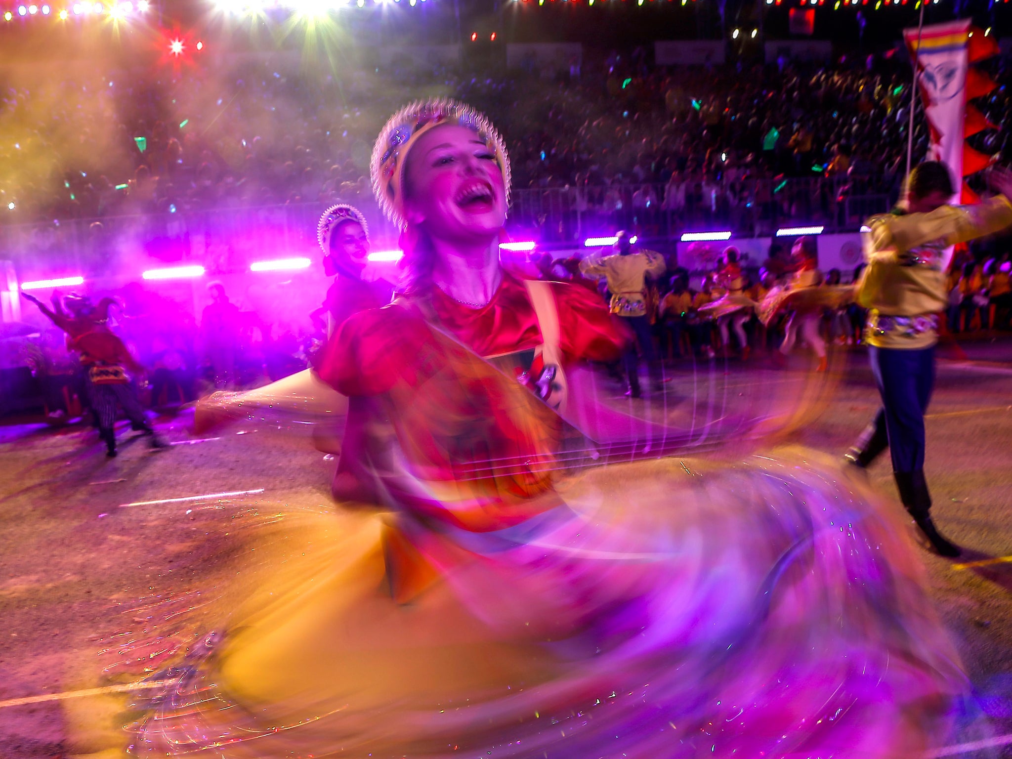 A slow shutter image of a Russian dancer spinning as she performs during the Chingay Parade in Singapore. Chingay, which means 'the art of costume and masquerade' in the Hokkien dialect features local and international performances and marks the tail end of the Lunar New Year festive period