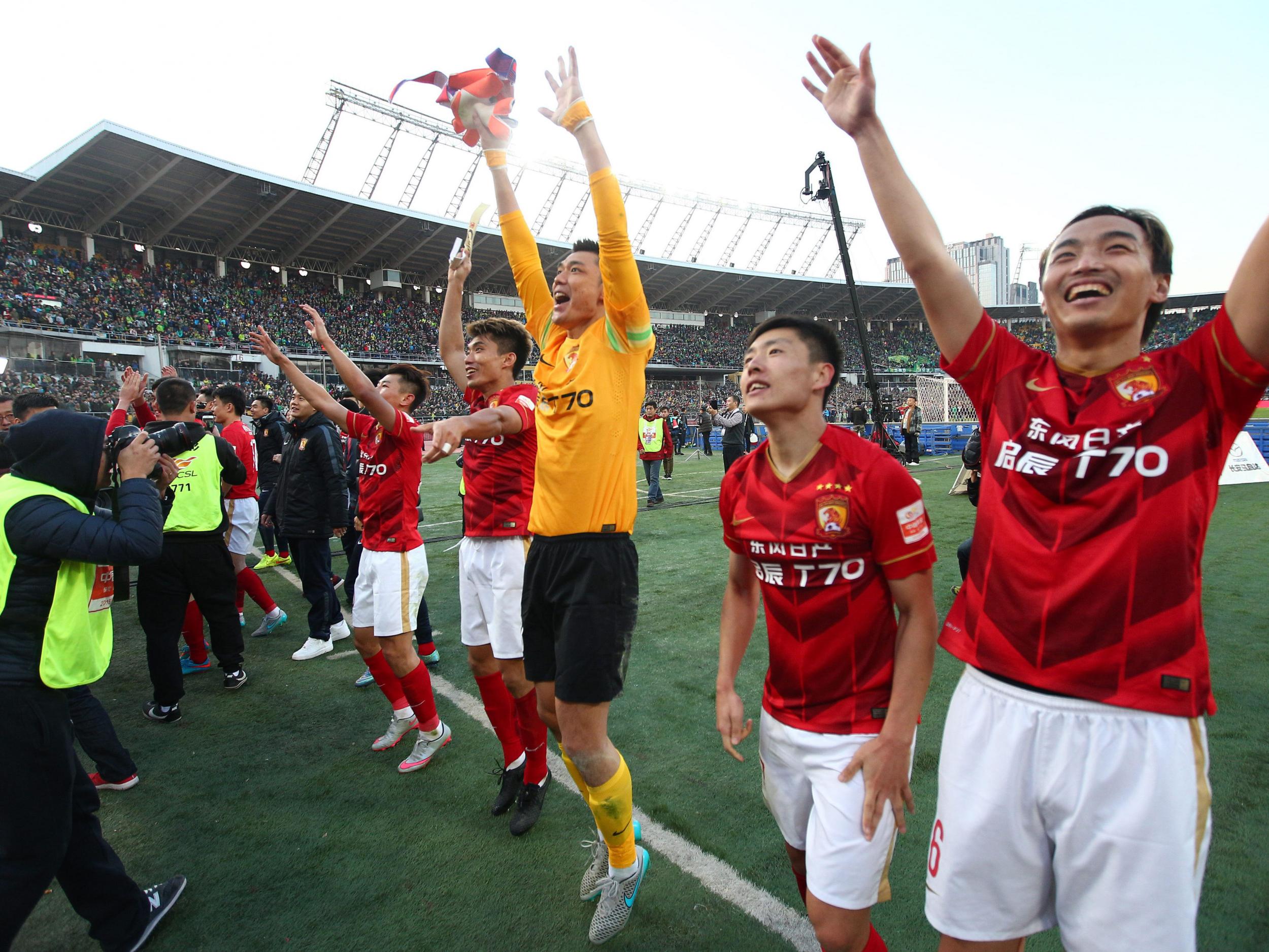 Guangzhou Evergrande's players celebrate after clinching the Chinese football championship