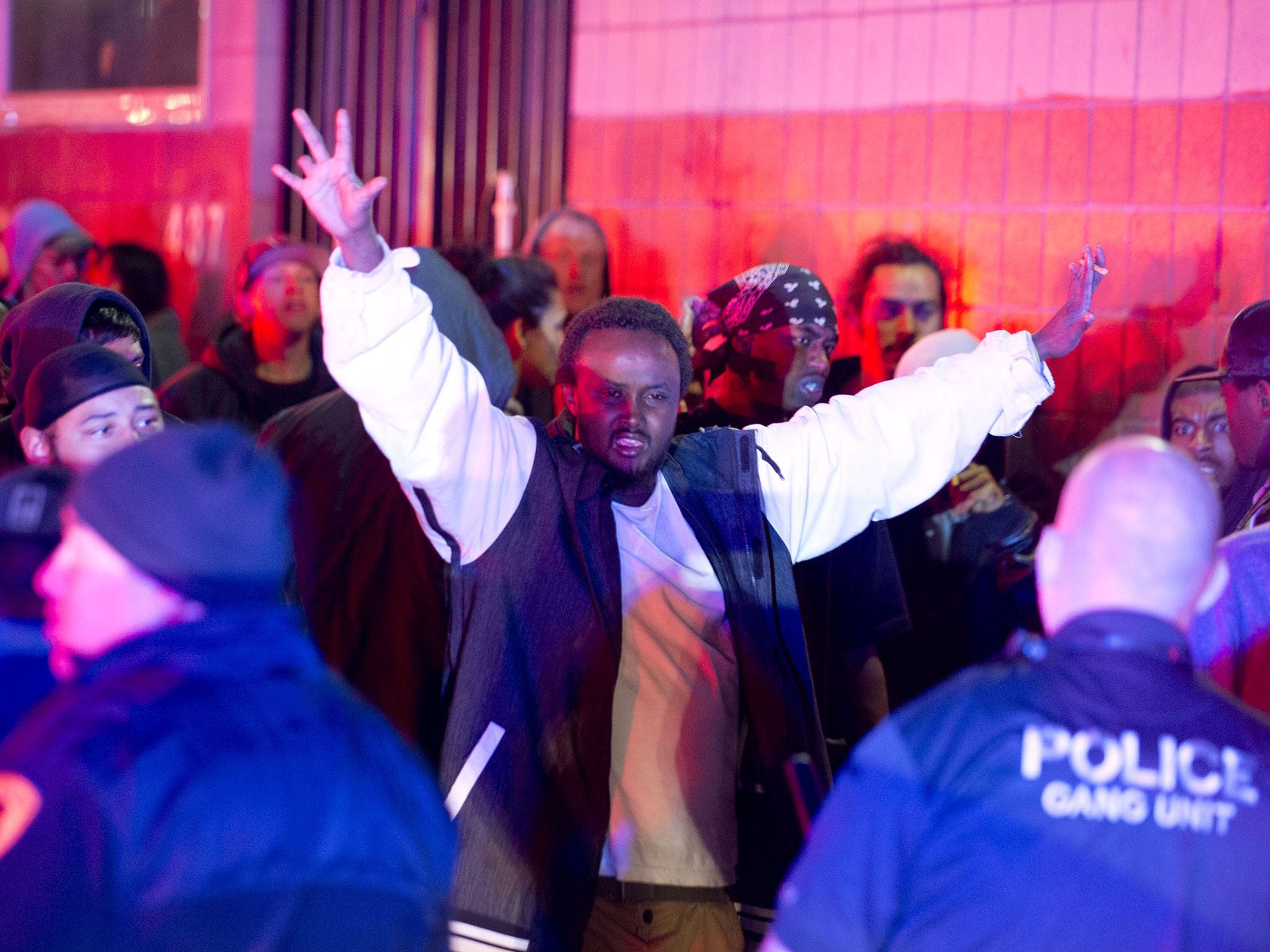 Police advance on an angry crowd following an officer-involved shooting at 200 South Rio Grande Street in Salt Lake City, Saturday, Feb. 27, 2016.