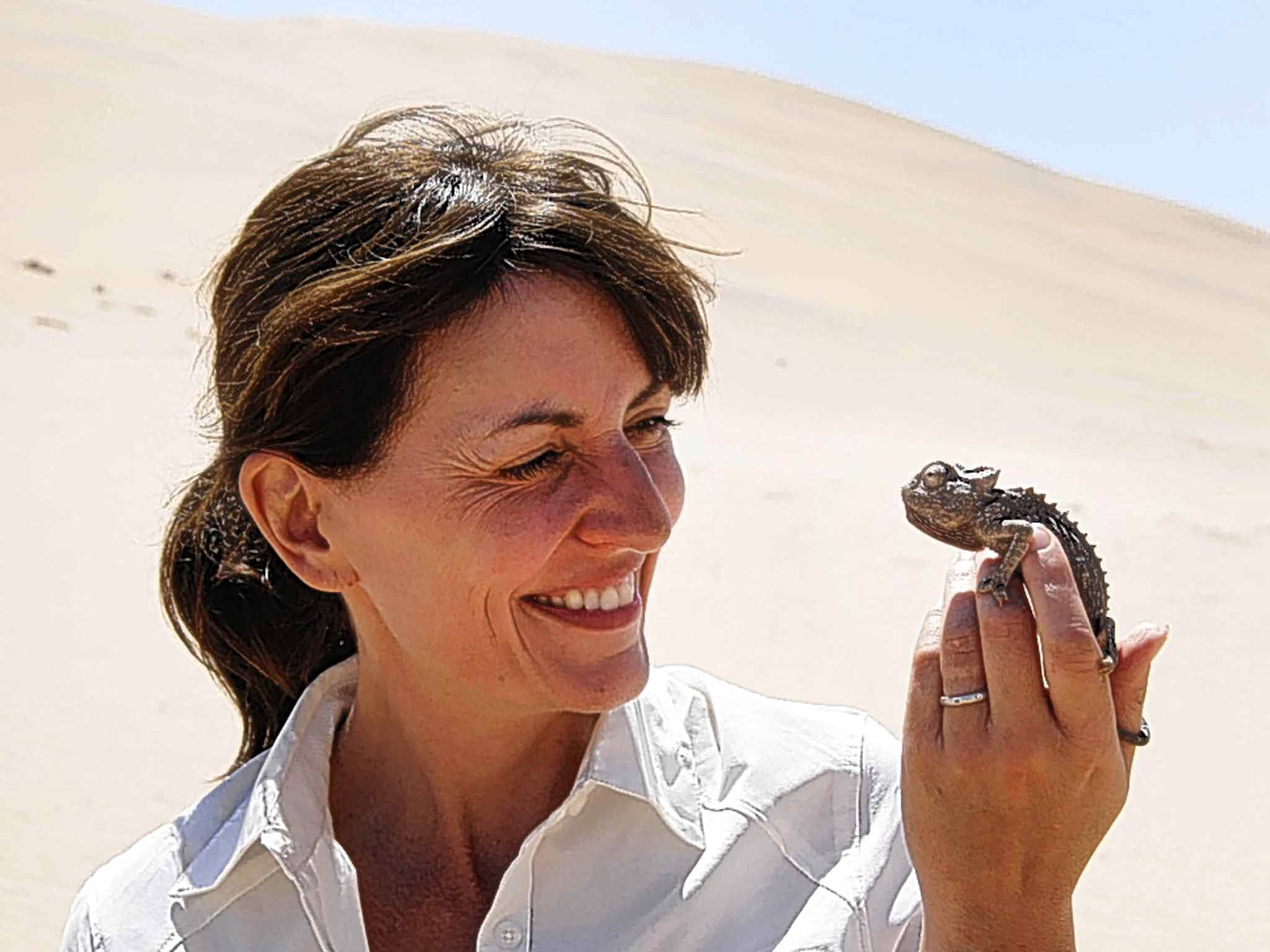 Hot spot: Davina McCall holds a black chameleon in the dunes of the Namib Desert