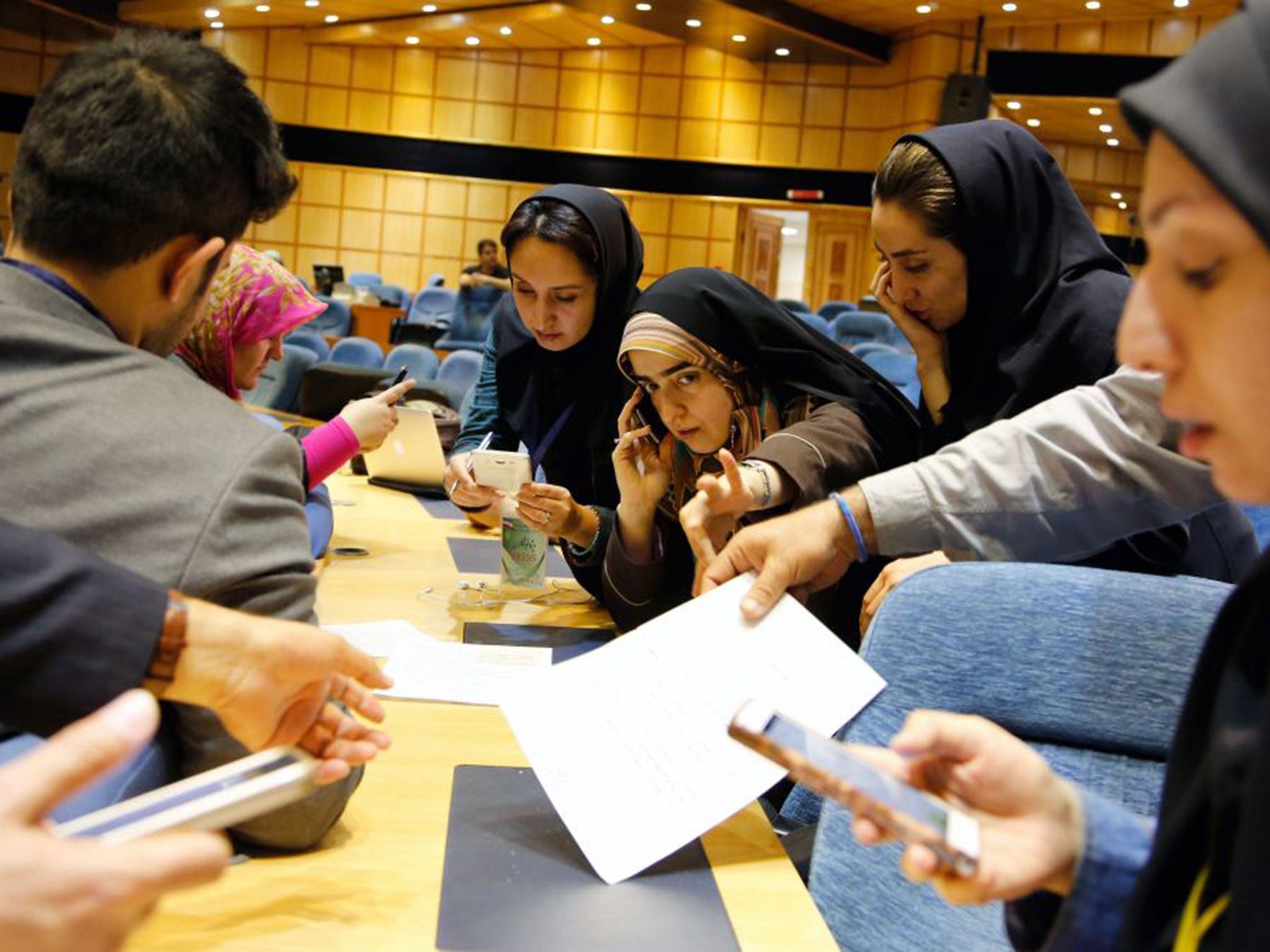 Iranian journalists follow the preliminary results in Tehran