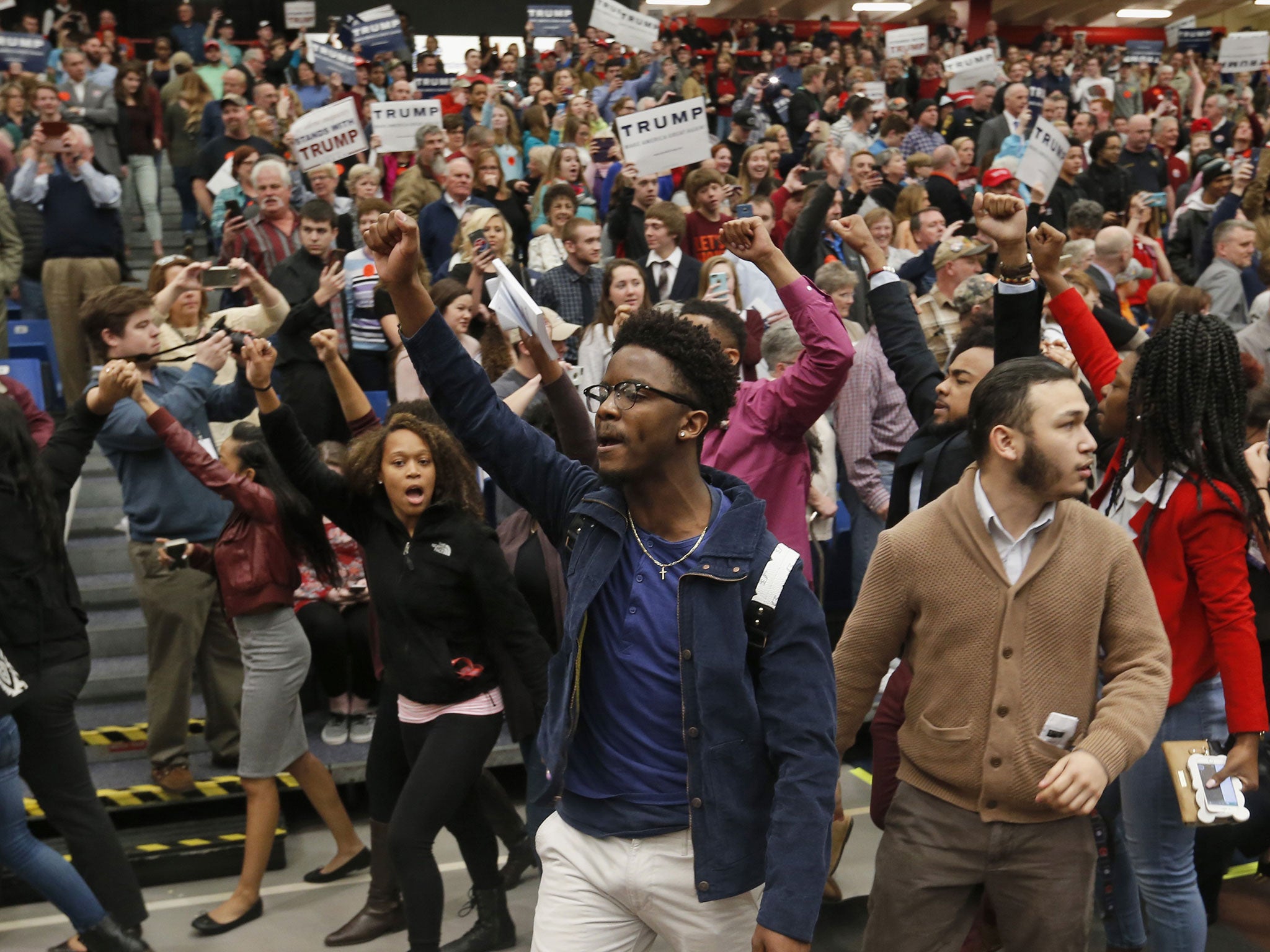 Protesters are escorted out of a rally for Republican presidential candidate, Donald Trump at Radford University in Radford, Va., Monday, Feb. 29, 2016.