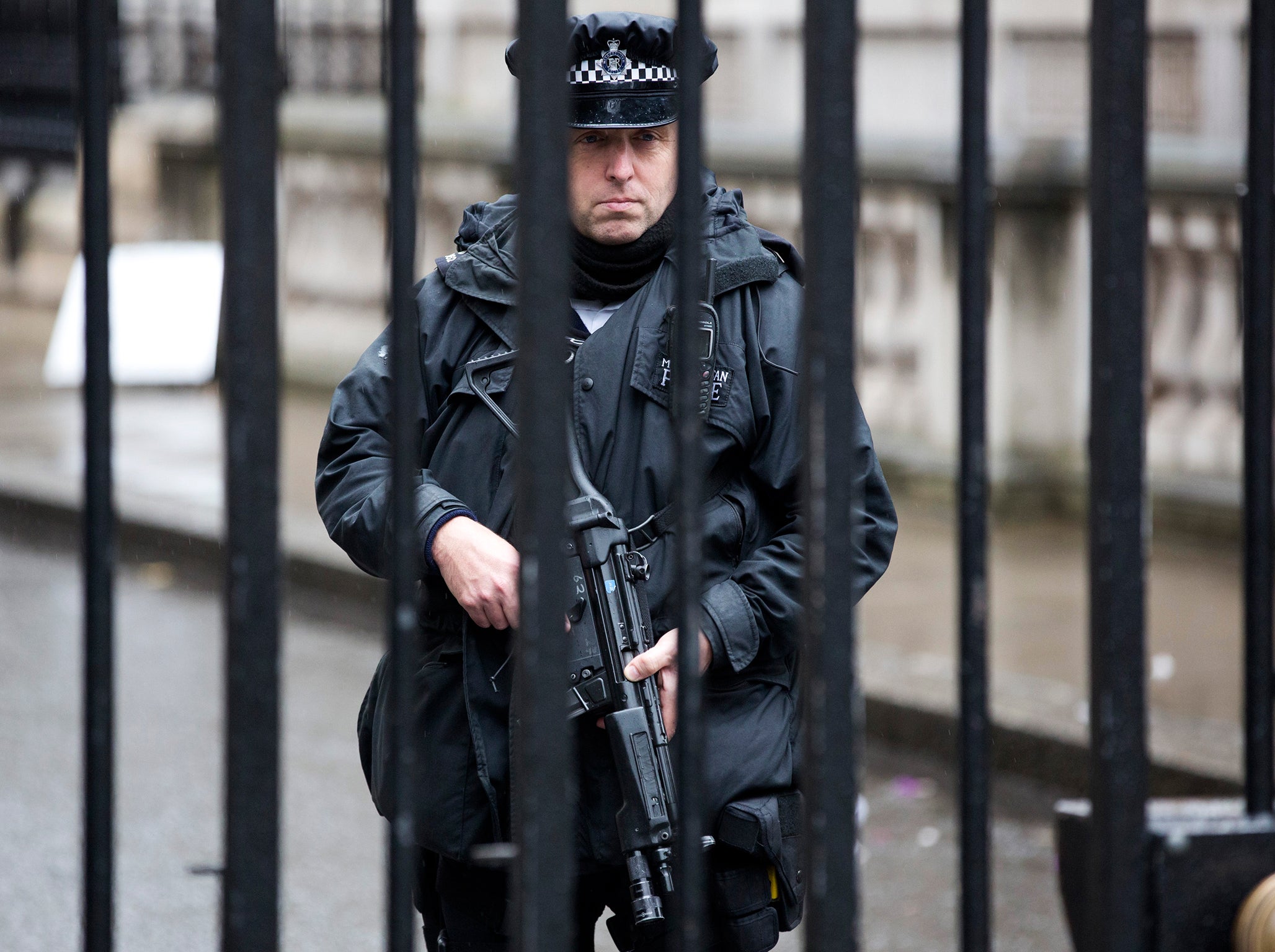 A police officer stands guard at the security gates at Downing Street in London