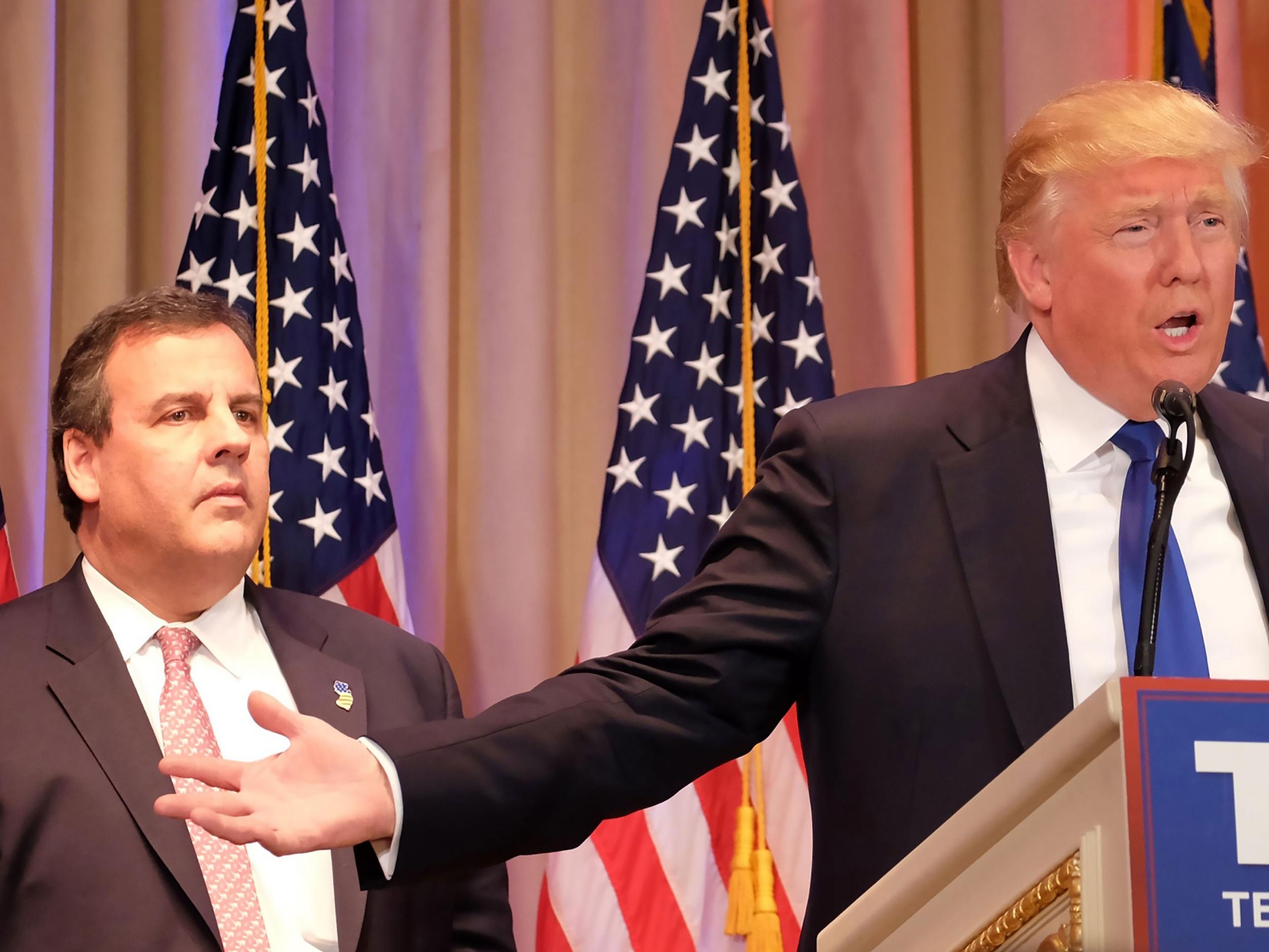 New Jersey Governor and former White House hopeful Chris Christie listens as Donald Trump speaks during a campaign event