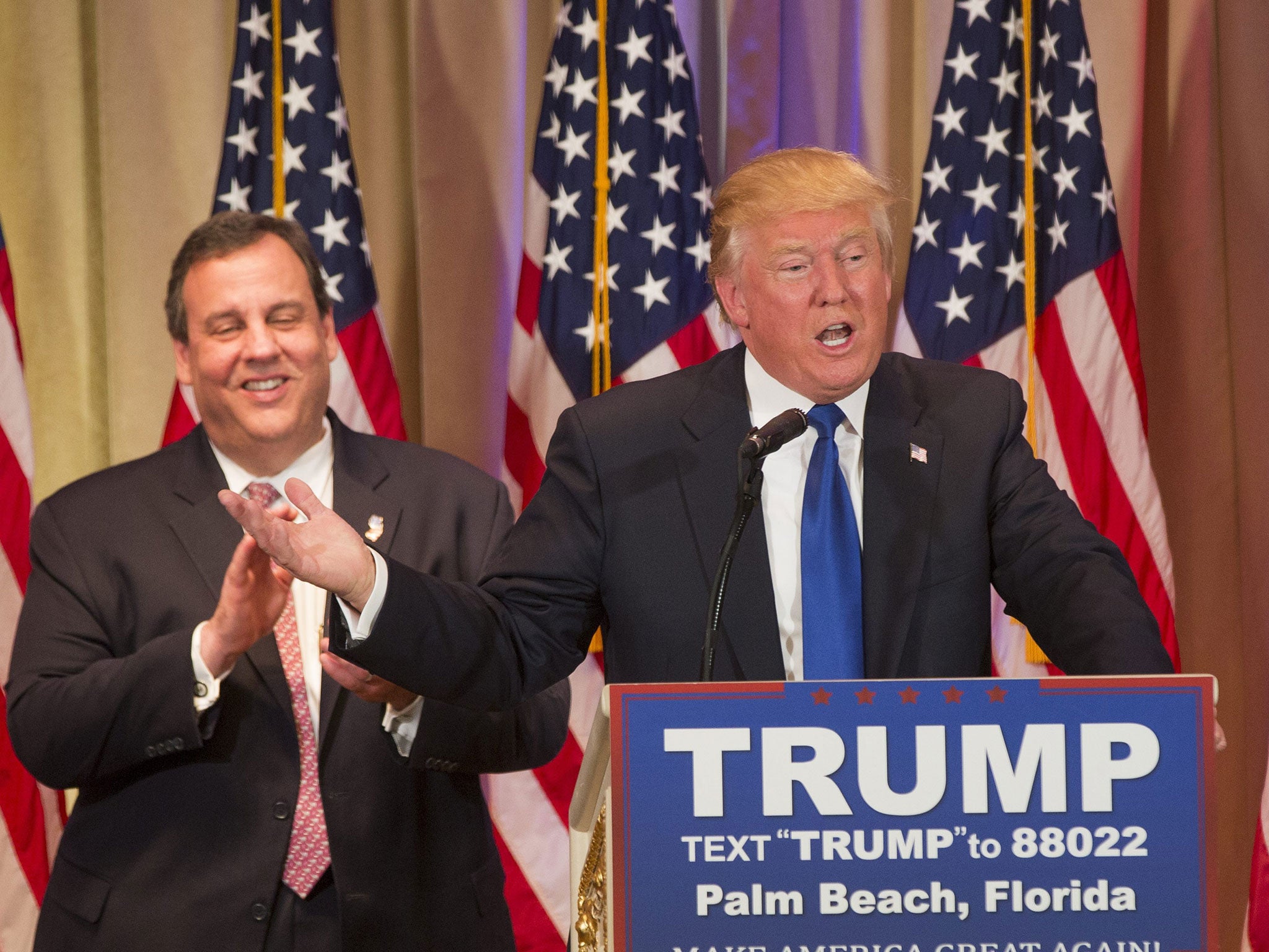 Donald Trump speaks, after being introduced by New Jersey Governor Chris Christie (L), at a Super Tuesday campaign event in Palm Beach, Florida