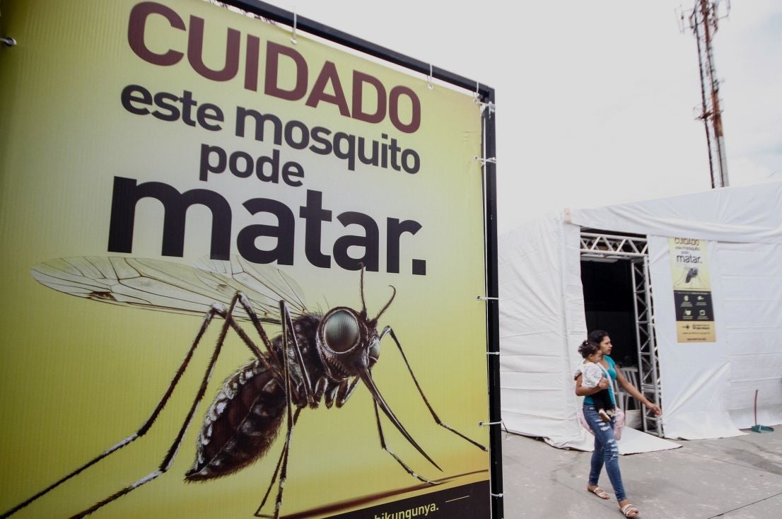 A woman walks pass a tent for accompanying suspected cases of dengue, zika and chinkungunya, in Sao Paulo, Brazil