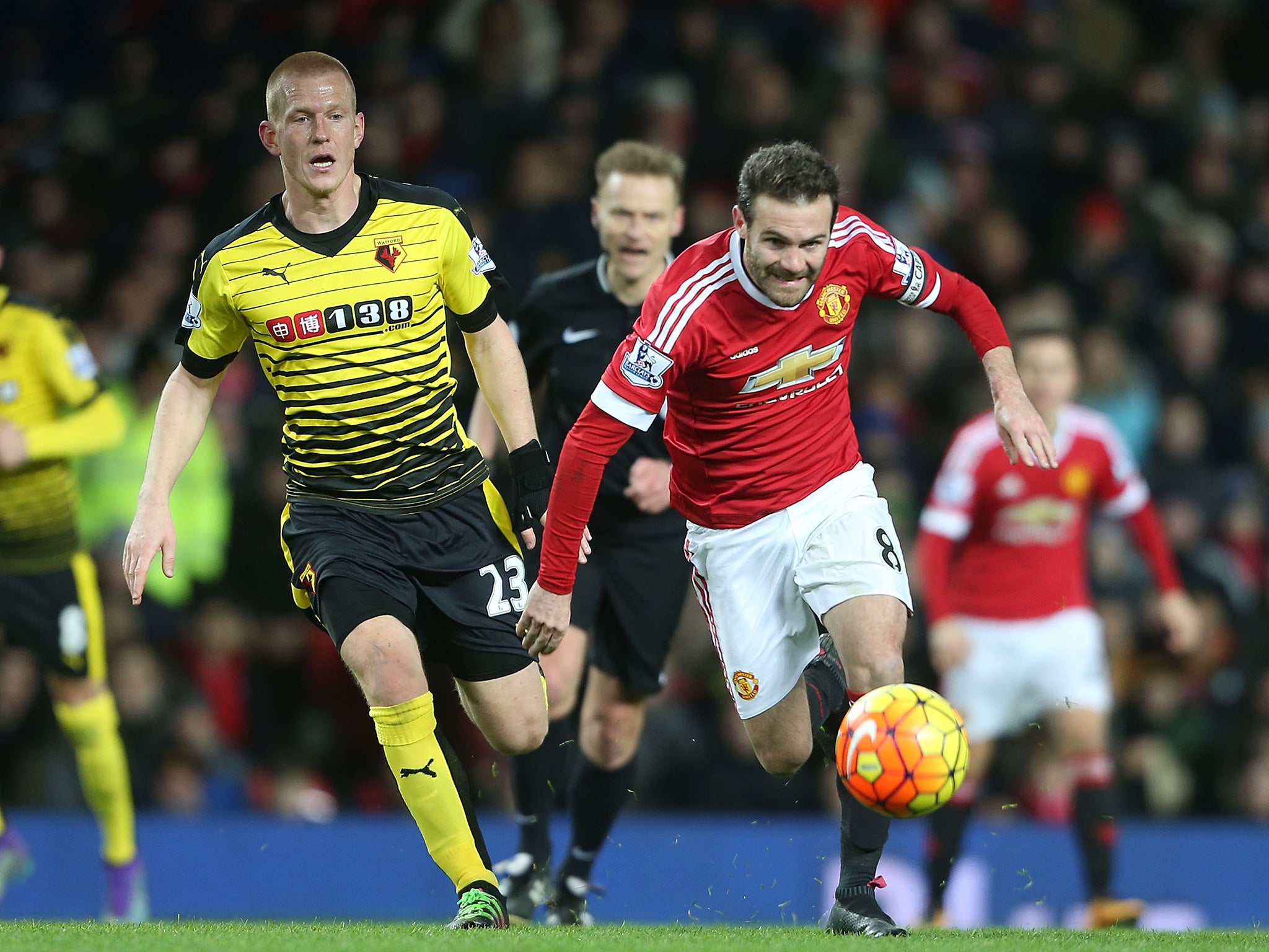 Juan Mata chases after the ball ahead of Ben Watson