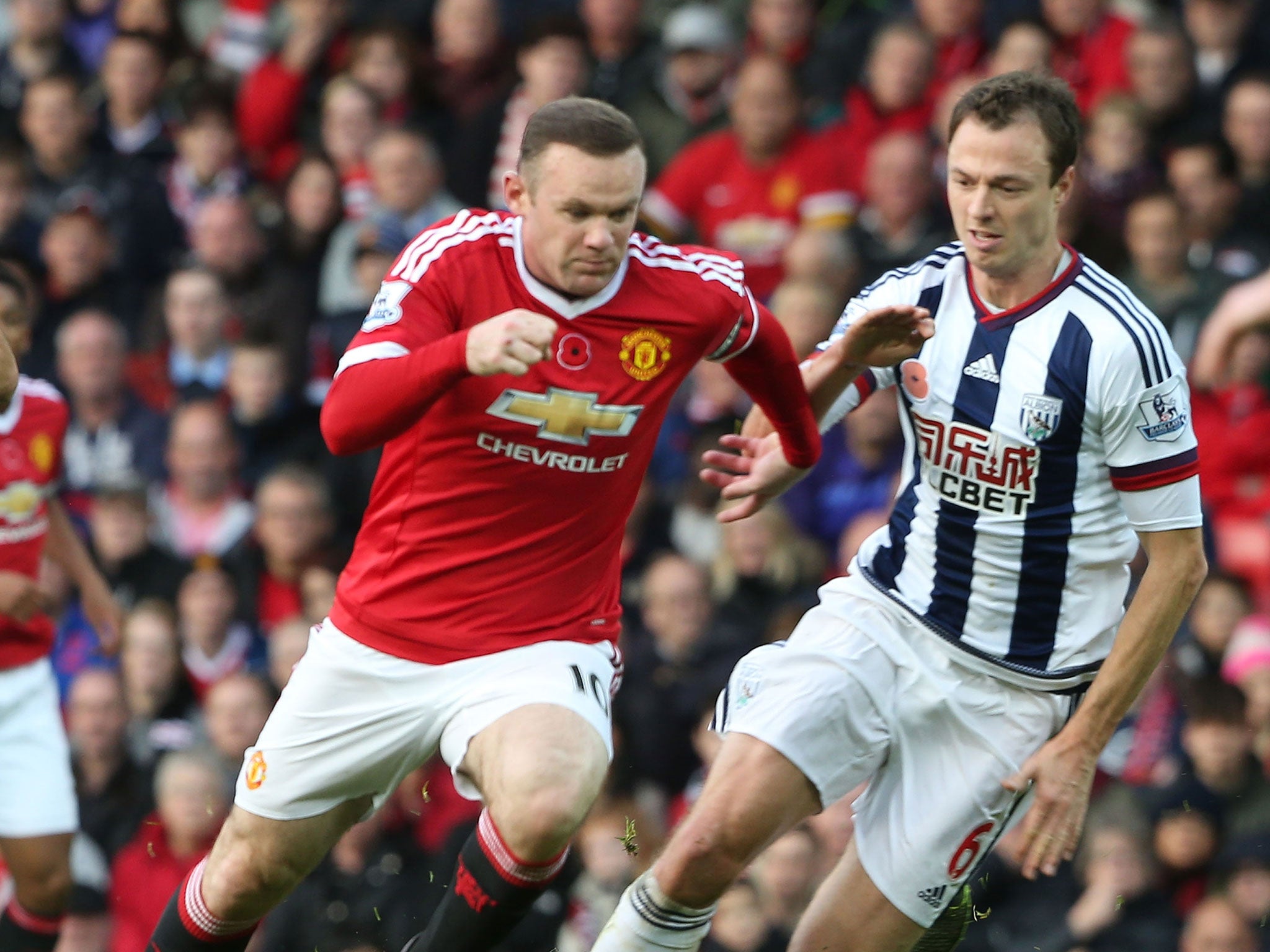Jonny Evans, right, goes up against his former Manchester United team-mate Wayne Rooney earlier this season