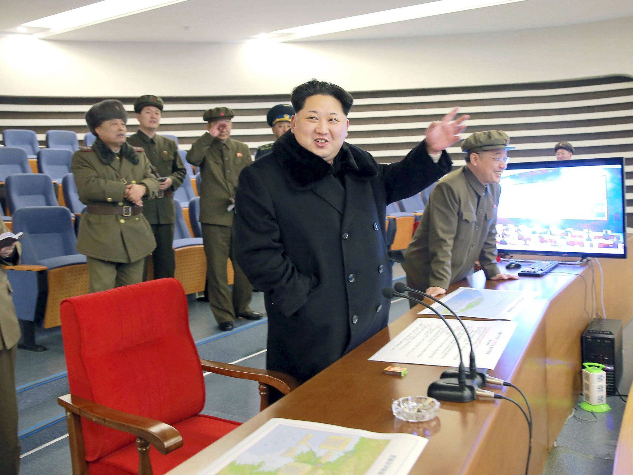 North Korean leader Kim Jong Un reacts as he watches a long range rocket launch in North Korea