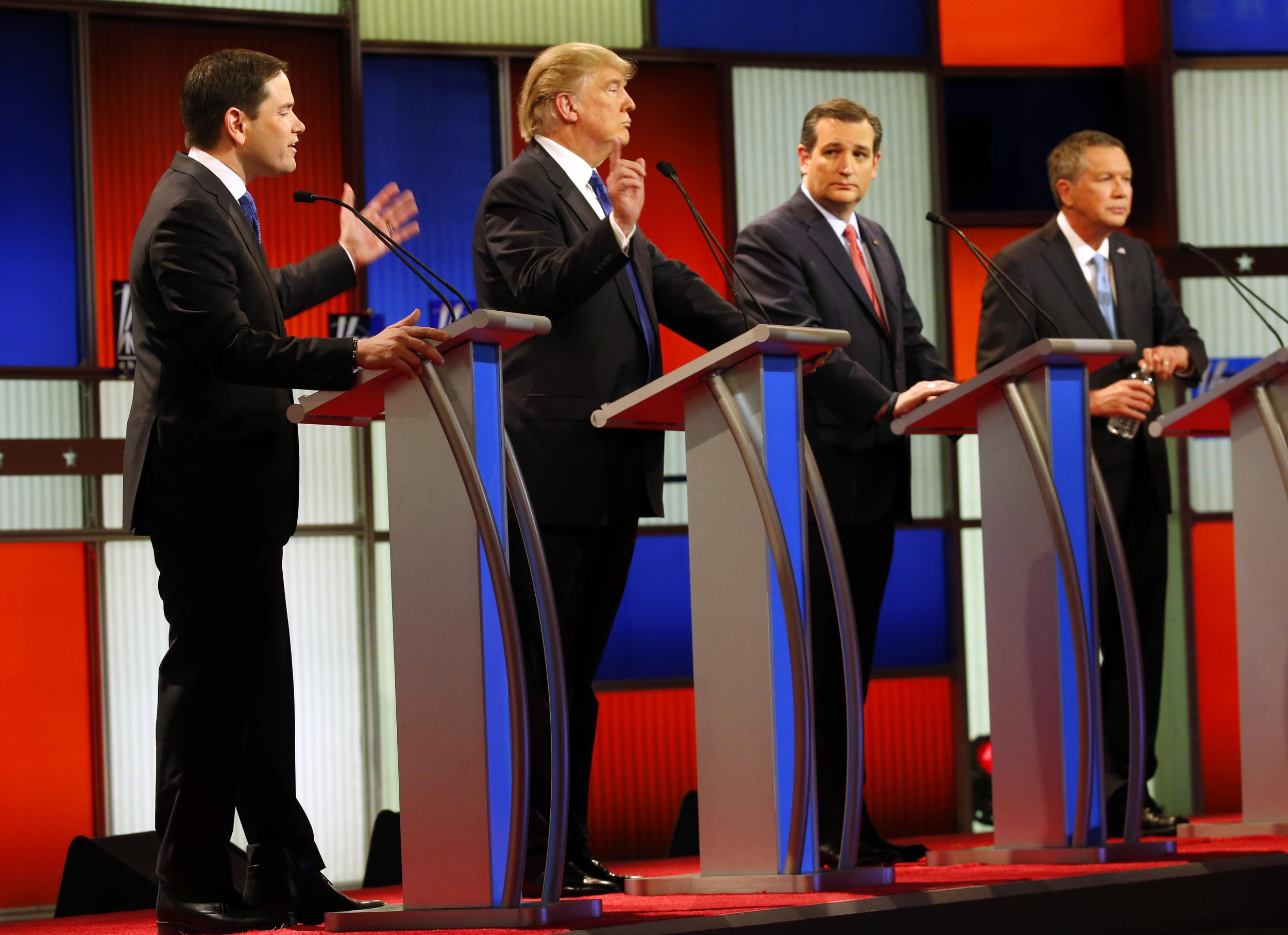 Republican presidential candidates, Sen. Marco Rubio, R-Fla., and businessman Donald Trump argue as Sen. Ted Cruz, R-Texas, and Ohio Gov. John Kasich listen during a Republican presidential primary debate