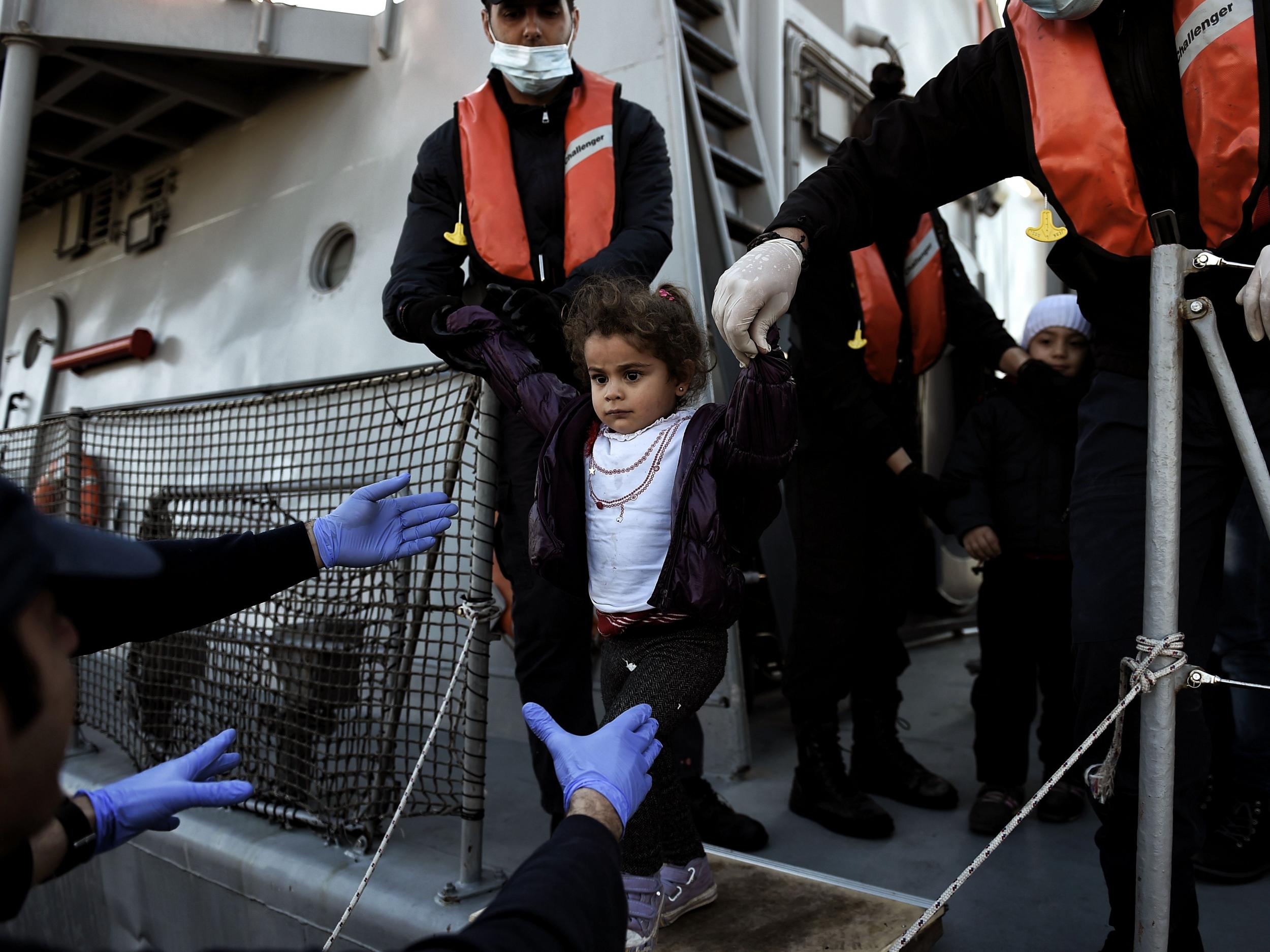 A migrant girl looks on upon arrival at the northern island of Lesbos after crossing the Aegean sea with other migrants and refugees from Turkey.