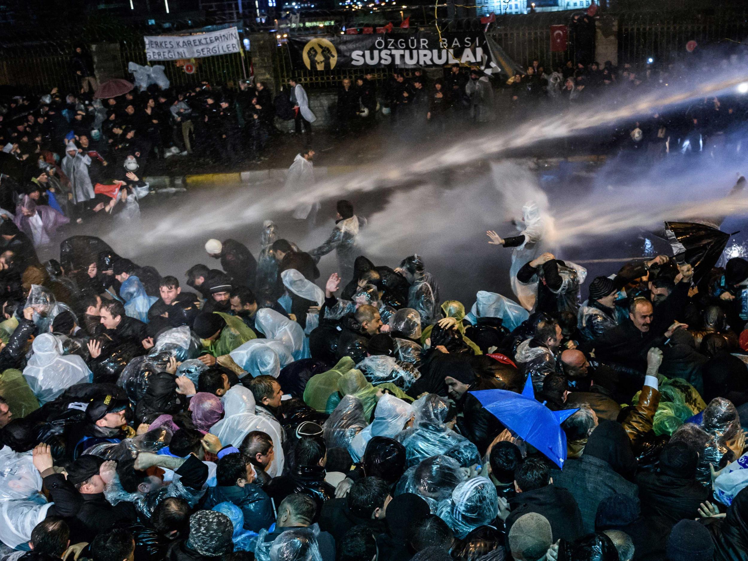 Turkish riot police use water cannon and tear gas to disperse supporters at Zaman daily newspaper headquarters