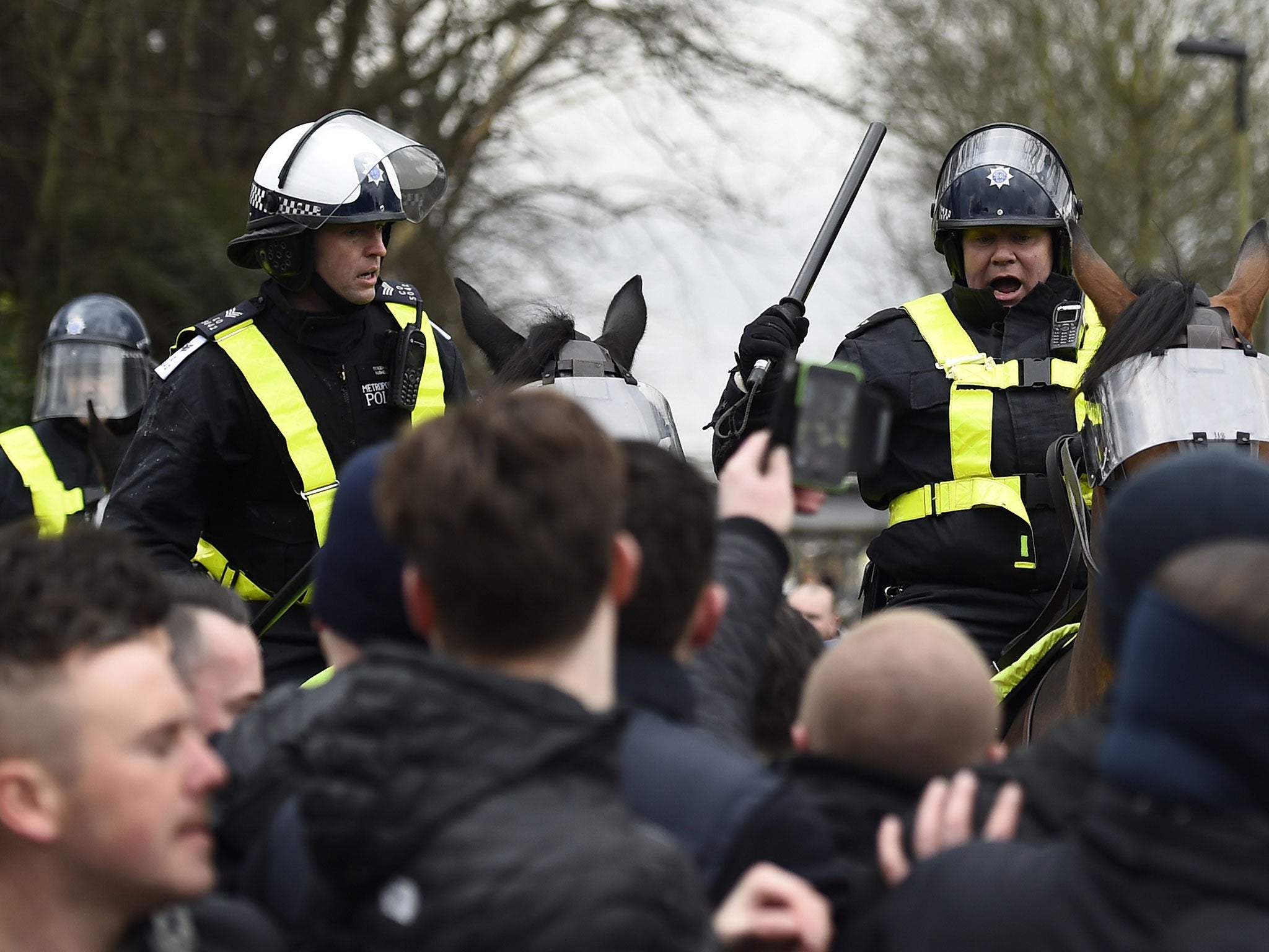 Police mounted on horses control the crowd