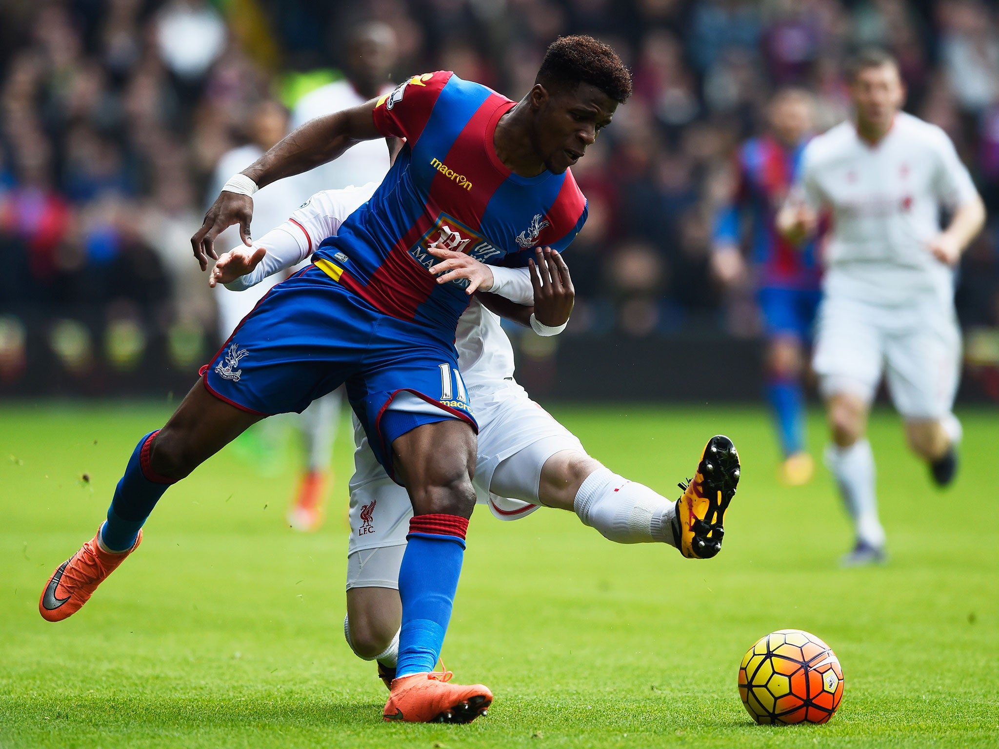 Wilfried Zaha is tackled by Alberto Moreno during Crystal Palace vs Liverpool