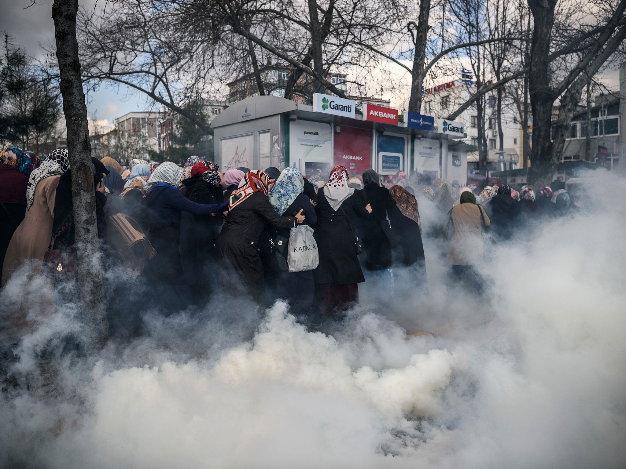 Turkish riot police deploy tear gas against protesters outside the offices of bestselling daily newspaper ‘Zaman’