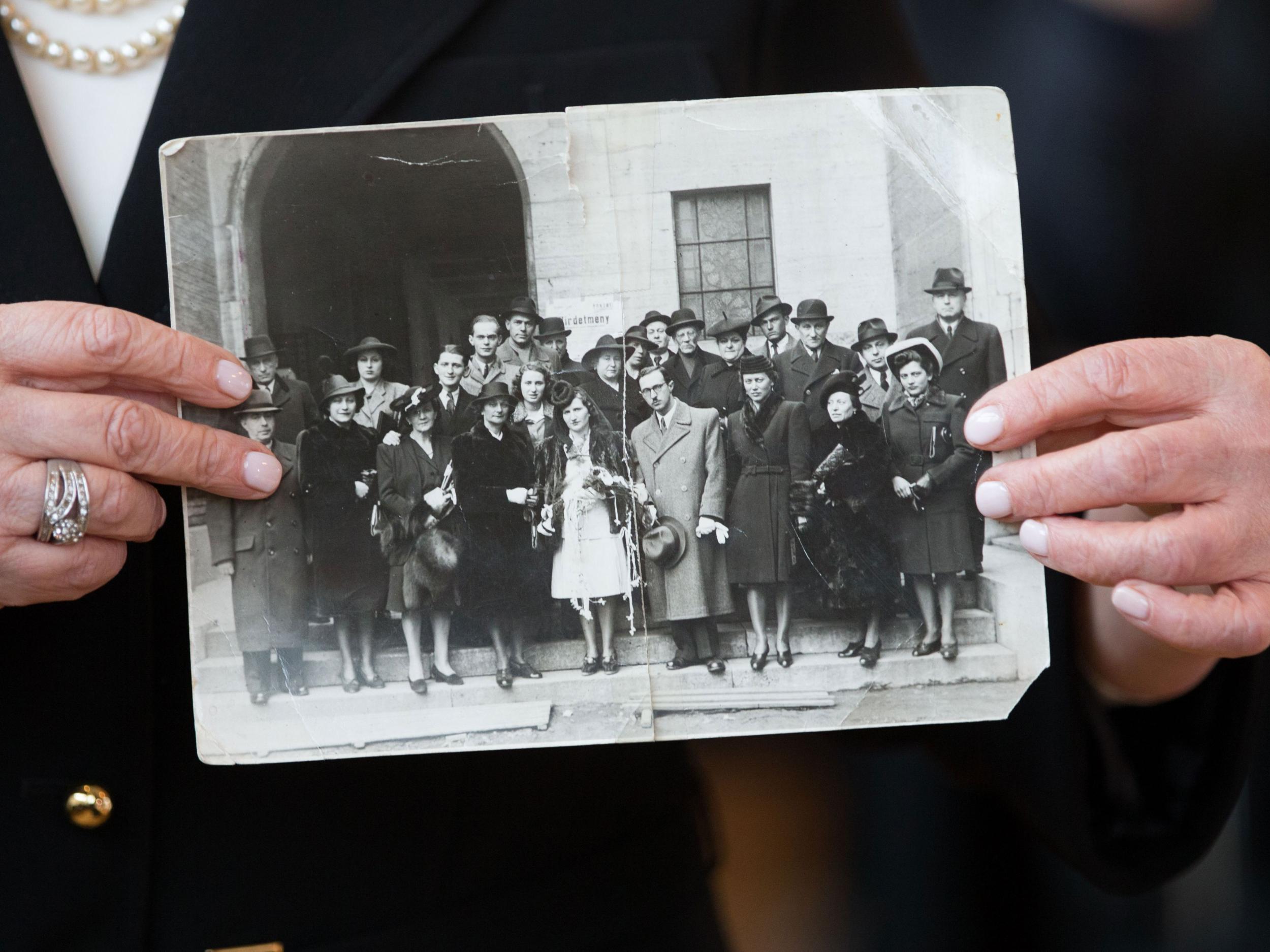 Witness Angela Orosz who was born in Auschwitz shows a photo of her parents wedding guests, while attending the trial of former Nazi death camp SS guard Reinhold Hanning Getty