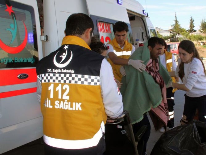 Medics take care of a rescued migrant at a local hospital in the Aegean resort of Didim, Turkey AP