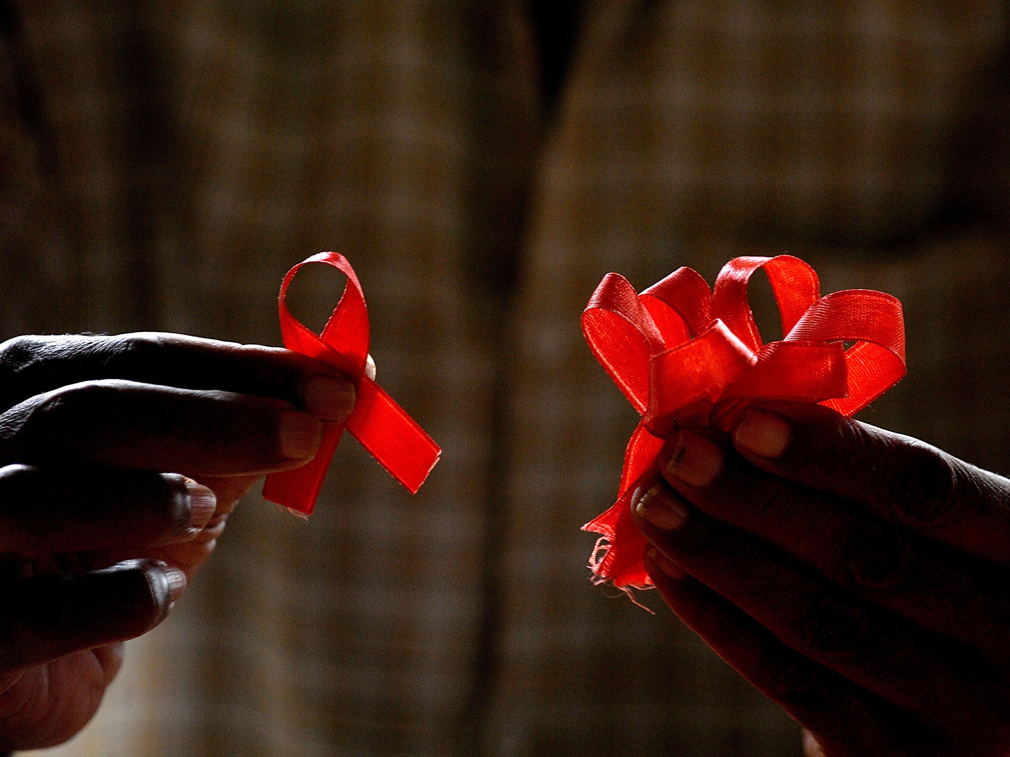 A charity worker in Bangalore, India, sorts through red ribbons