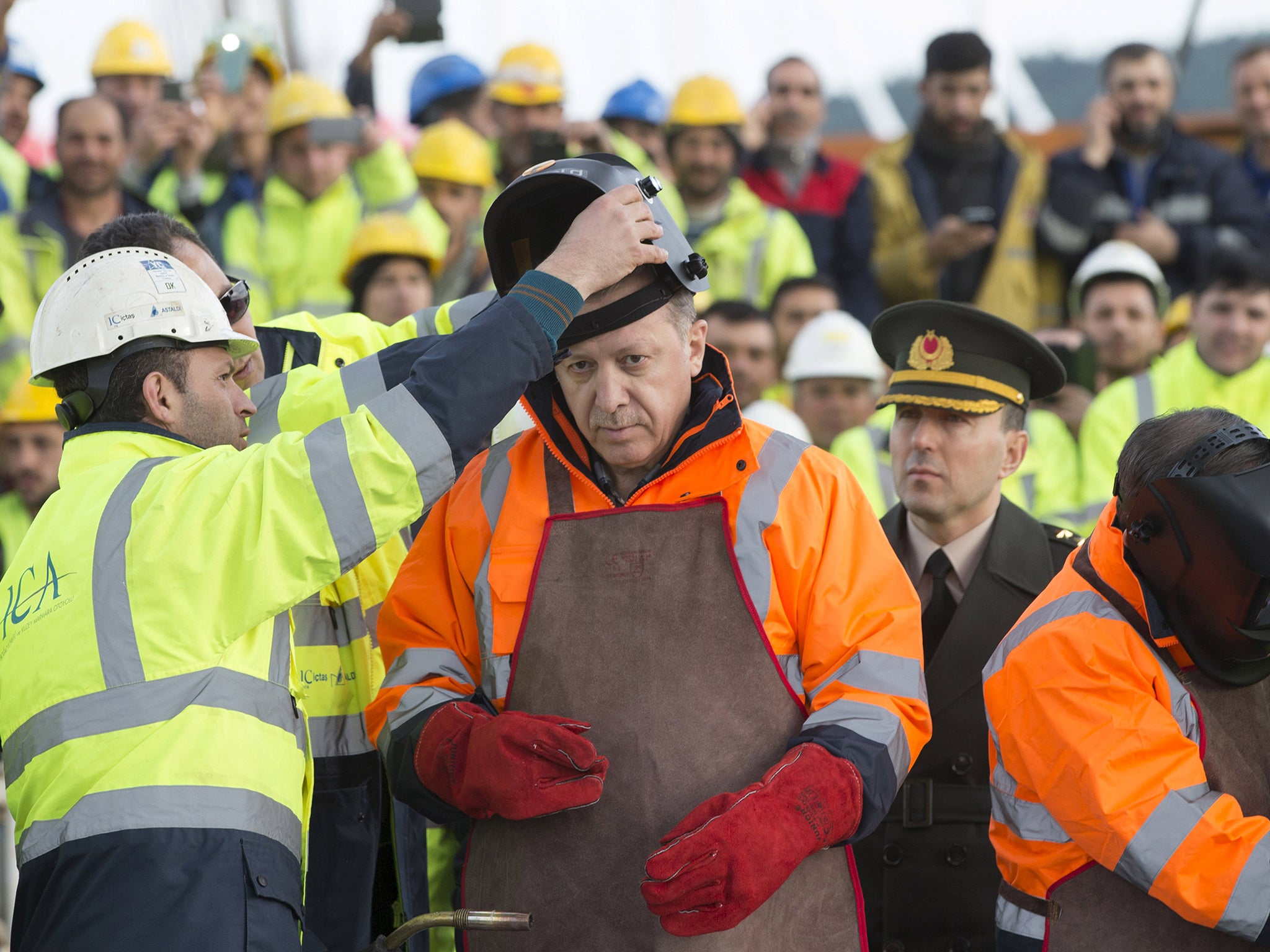 Turkey's President Tayyip Erdogan prepares for the welding of the final section of the Yavuz Sultan Selim Bridge, the Third Bosphorus Bridge, during a ceremony in Istanbul, Turkey