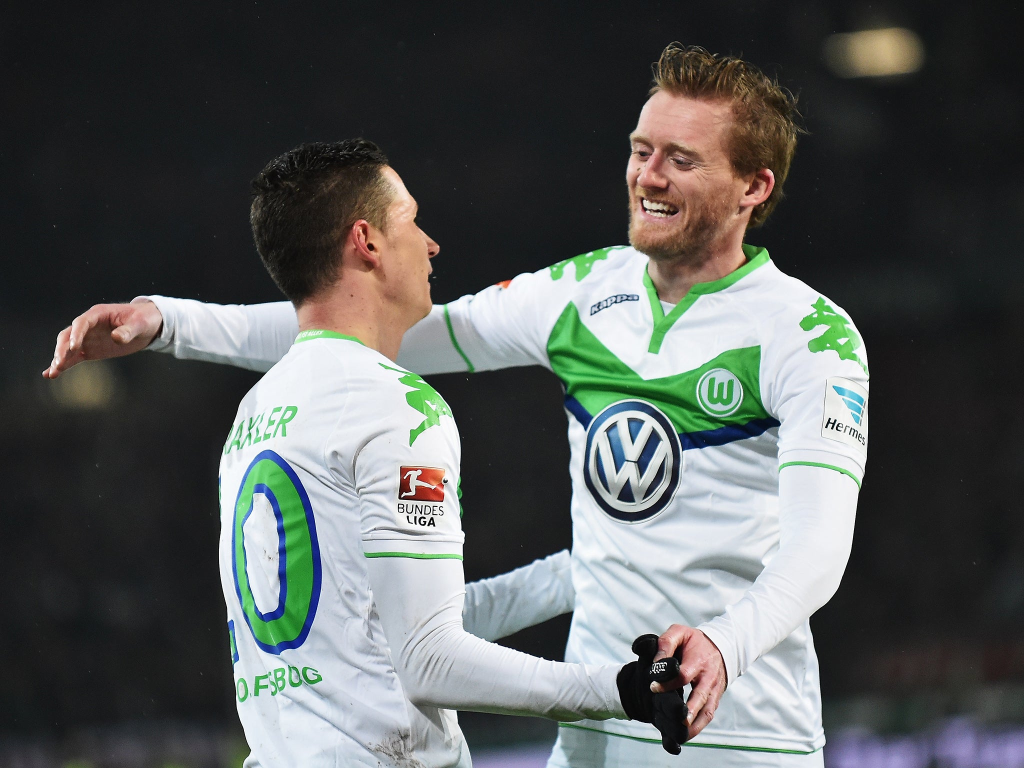 Wolfsburg forward Andre Schurrle celebrates with team-mate Julian Draxler