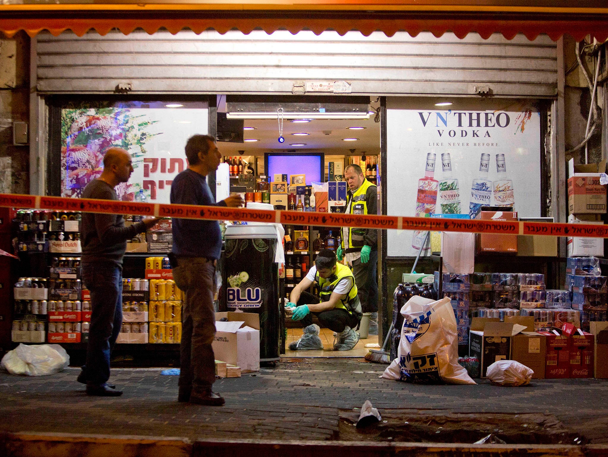 Israeli ZAKA emergency response members are seen at the scene of a stabbing attack in the central Israeli city of Petah Tikvah