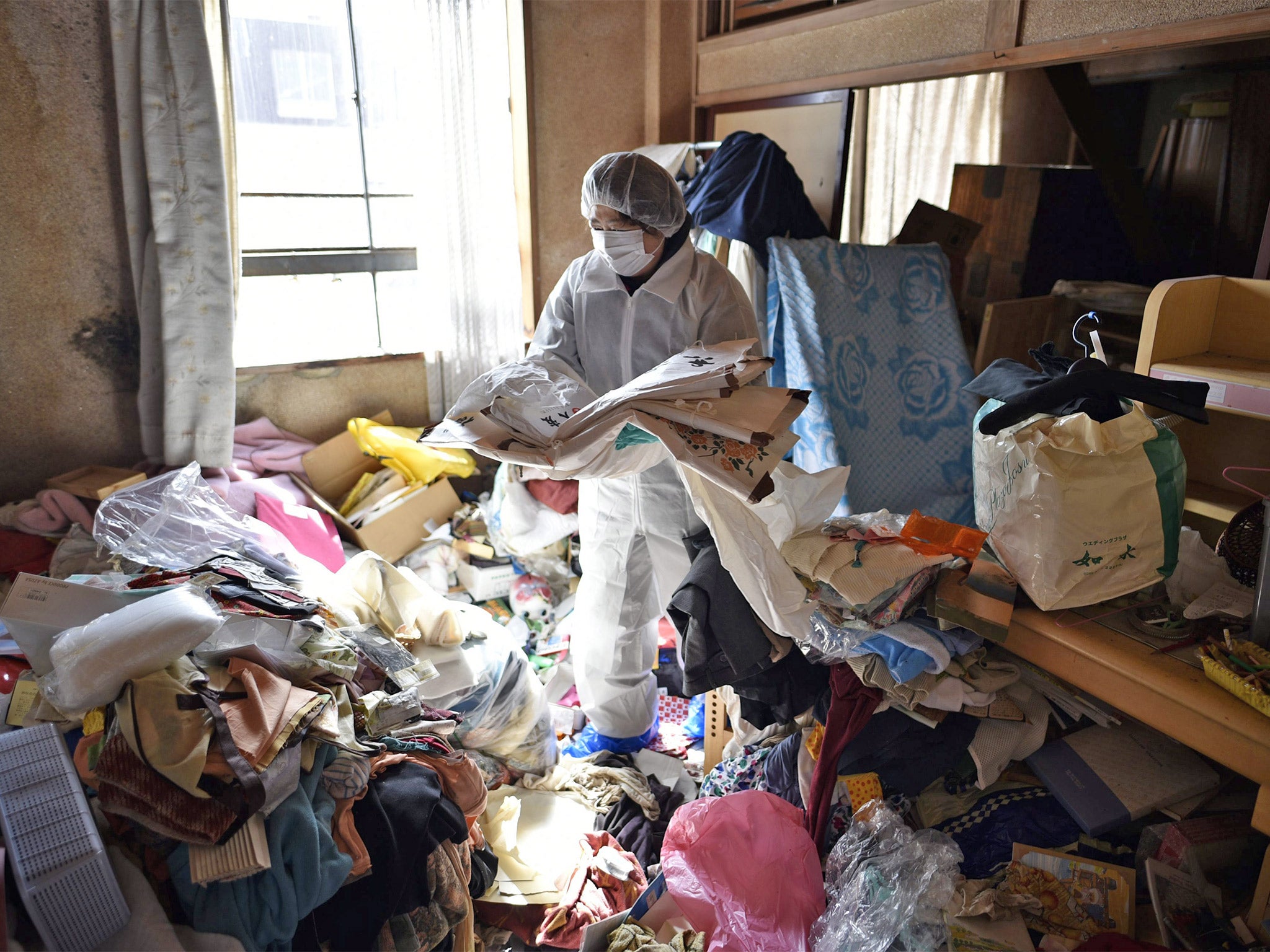 A resident returns briefly to her home last month