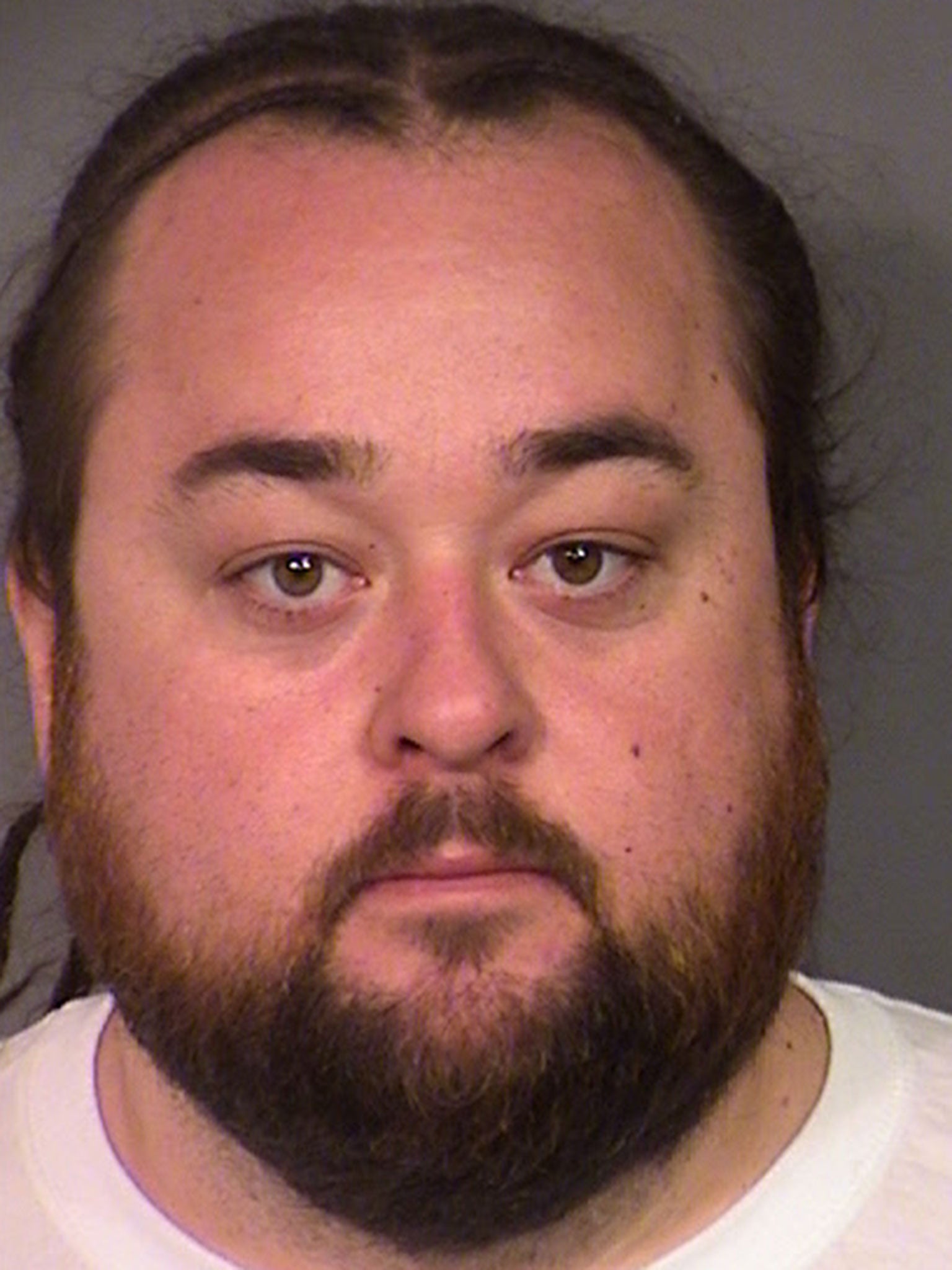 Police handout shows Austin 'Chumlee' Russell in a booking photo after his arrest for possession of a firearm and numerous narcotics including methamphetamine and marijuana during a sexual assault investigation raid at his home on 9 March, 2016 in Las Vegas, Nevada